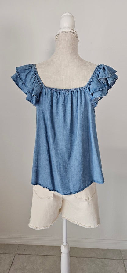 Look sharp and stylish this summer in our "Ashley Chambray Denim" top! Its flattering sweetheart neckline and sassy ruffle sleeves give you a unique, standout look. Plus, the square back neckline with elastic adds comfort! So why wait? Get out there and show off your denim 'look' with attitude. Sizes small through large.