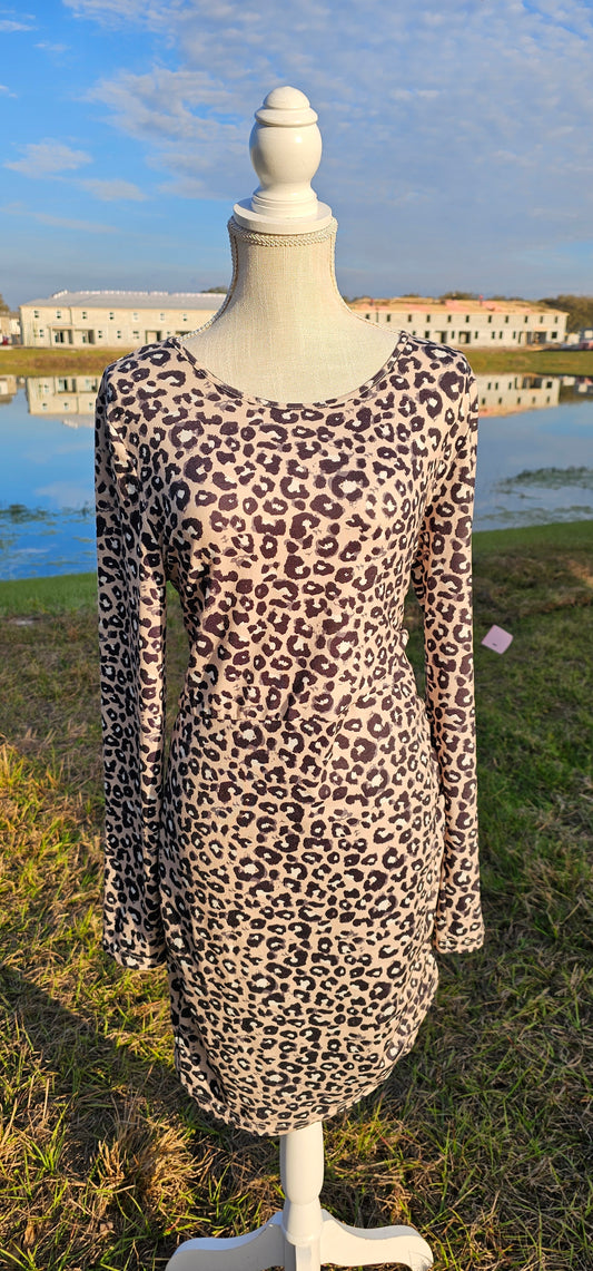 Get in touch with your wild side with this taupe, black and white ruched leopard, scoop neck, long sleeve dress. Imagine yourself wearing this cute number to the office, going out on the town, hanging out with family and friends, you will be comfortable whatever you choose to wear your dress to.  Have fun!  Grrrrrrrrrrrrrrrrr! Sizes small through x-large.