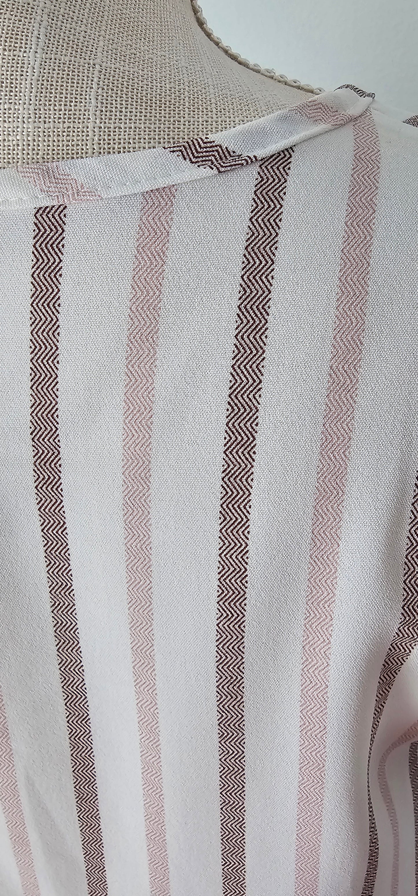 Look as sweet as a summer's day in this "Heather Striped Taupe" top! With cute flutter sleeves, a split round neckline, and a playful front-fold detail, you'll be ready for any outdoor adventure! And just to top it off, the taupe stripes add an extra bit of pizzazz. Who said stripes have to be boring?! Size small through large.