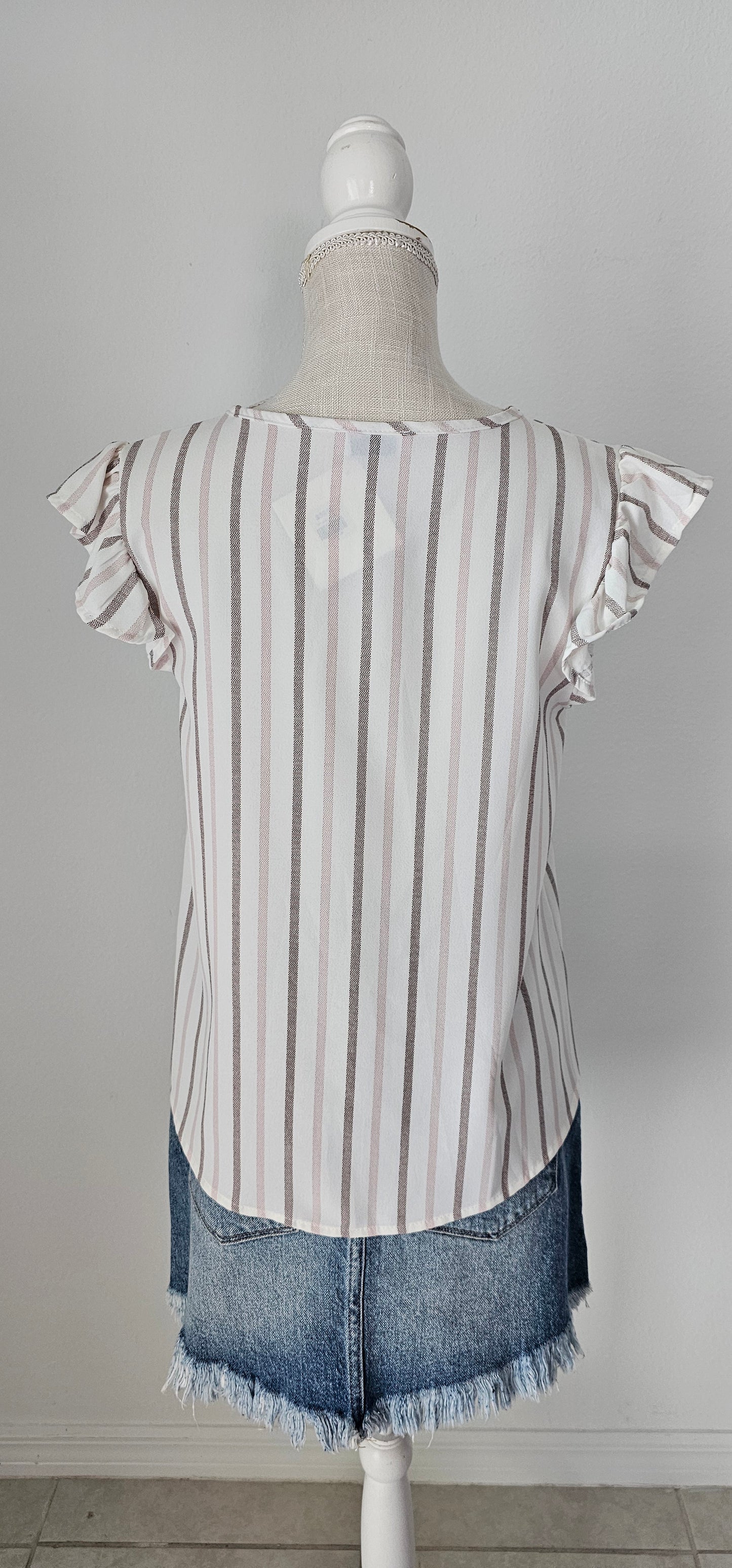 Look as sweet as a summer's day in this "Heather Striped Taupe" top! With cute flutter sleeves, a split round neckline, and a playful front-fold detail, you'll be ready for any outdoor adventure! And just to top it off, the taupe stripes add an extra bit of pizzazz. Who said stripes have to be boring?! Size small through large.