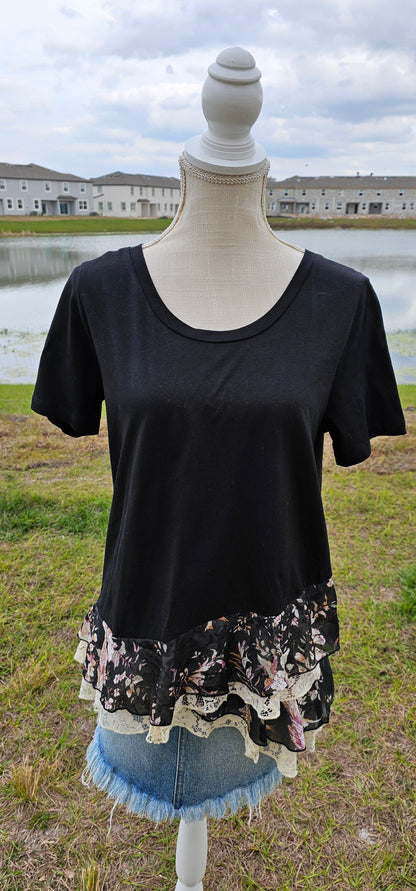 This is a comfy and casual black top, which features short sleeves, rounded neckline, layering lace and layering flowery print bottom. This is a great staple piece to your wardrobe. Sizes small through large.
