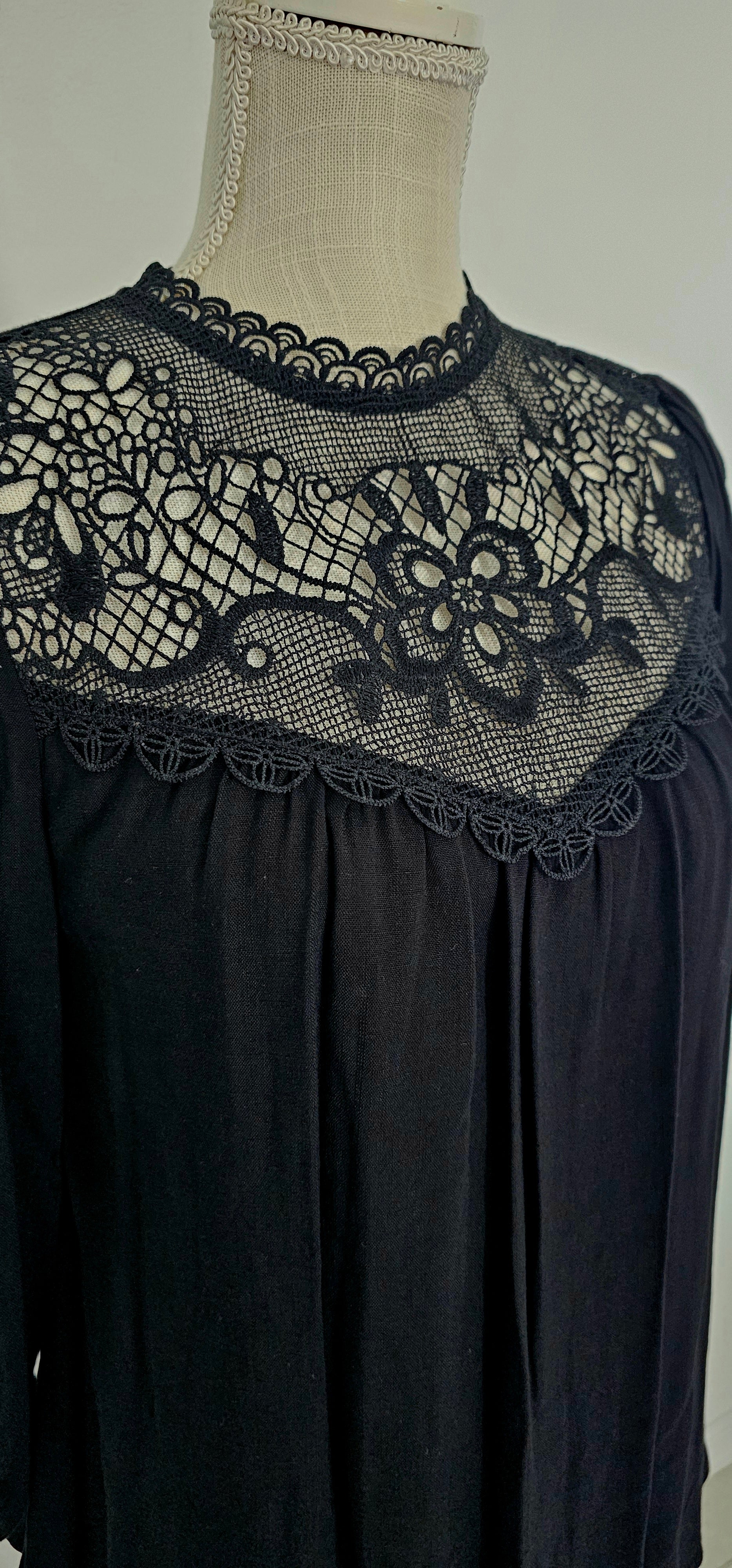 Rock your look with this ravishing&nbsp;top that'll take your fashion to the next level! With its elegant lace mock neck, stylish back-button closure with keyhole, and oh-so-pretty front lace inset and pleated bubble sleeves, you'll be sure to draw admiring glances wherever you go. Let's get fabulous! Sizes small through large.