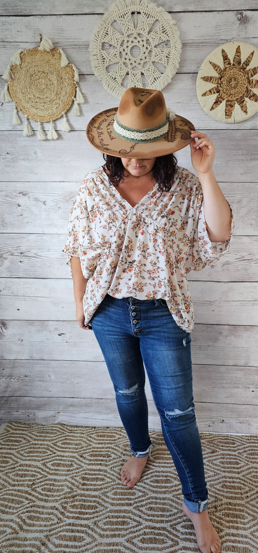 “Rosy Future” is a ivory loose fitting, flowy top. It features a rosy floral print, v-neck and v-back, pleated sleeves. This top is sheer but not see through. It is great for vacation, an evening out or casual event. Sizes small through large.