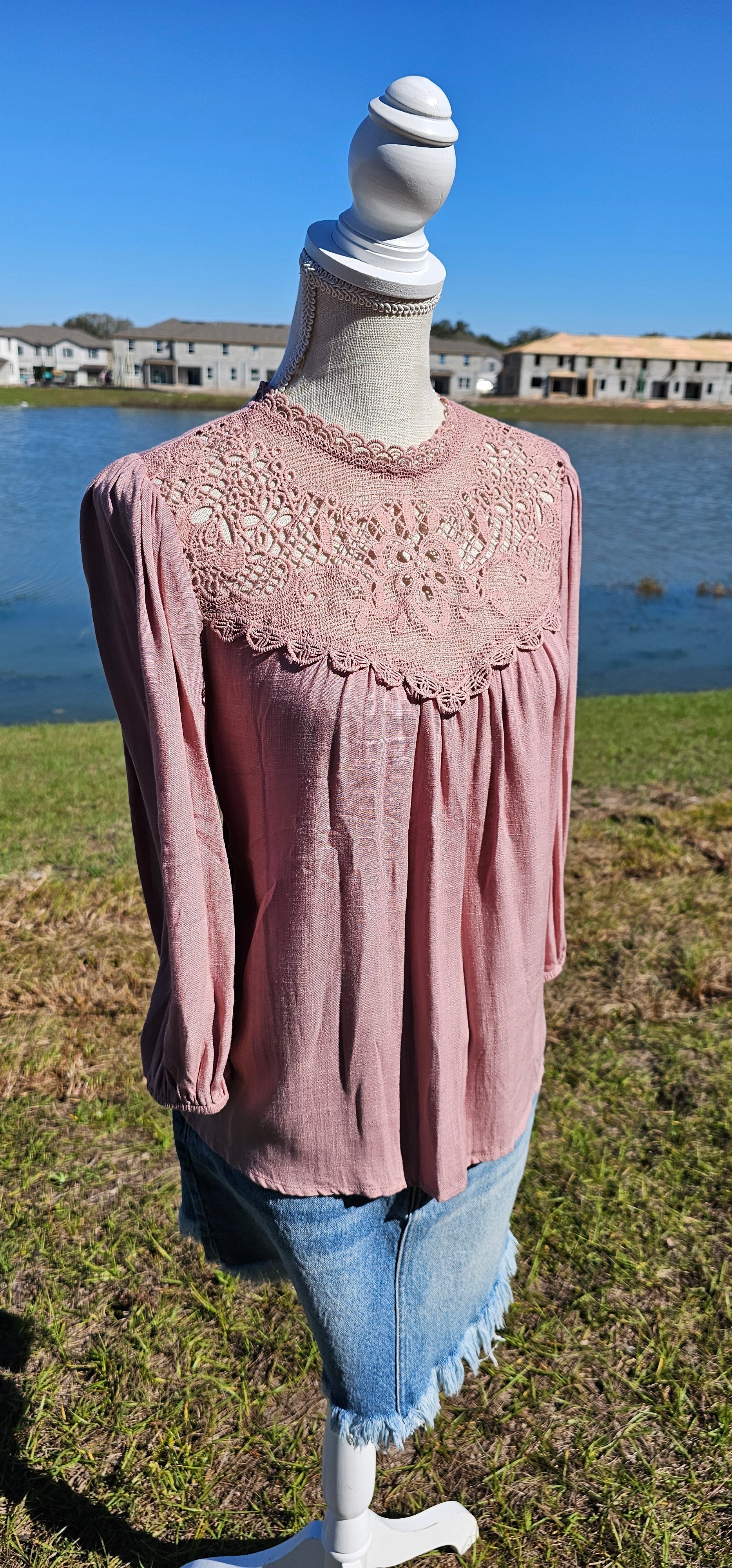 Rock your look with this ravishing top that'll take your fashion to the next level! With its elegant lace mock neck, stylish back-button closure with keyhole, and oh-so-pretty front lace inset and pleated bubble sleeves, you'll be sure to draw admiring glances wherever you go. Let's get fabulous! Sizes small through large.