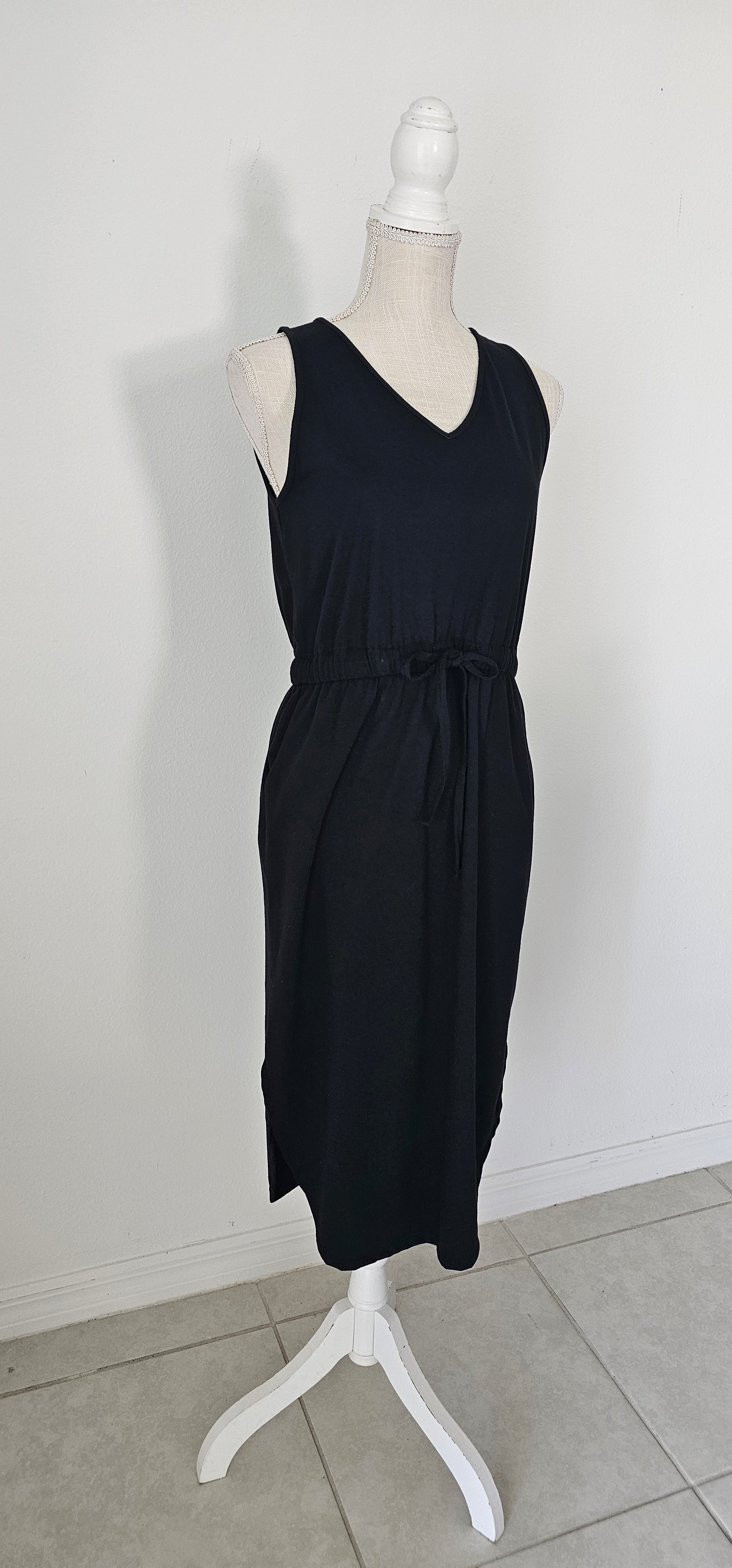 Poly cotton drawstring elastic waist curved hem dress with pockets. Sizes small through x-large.