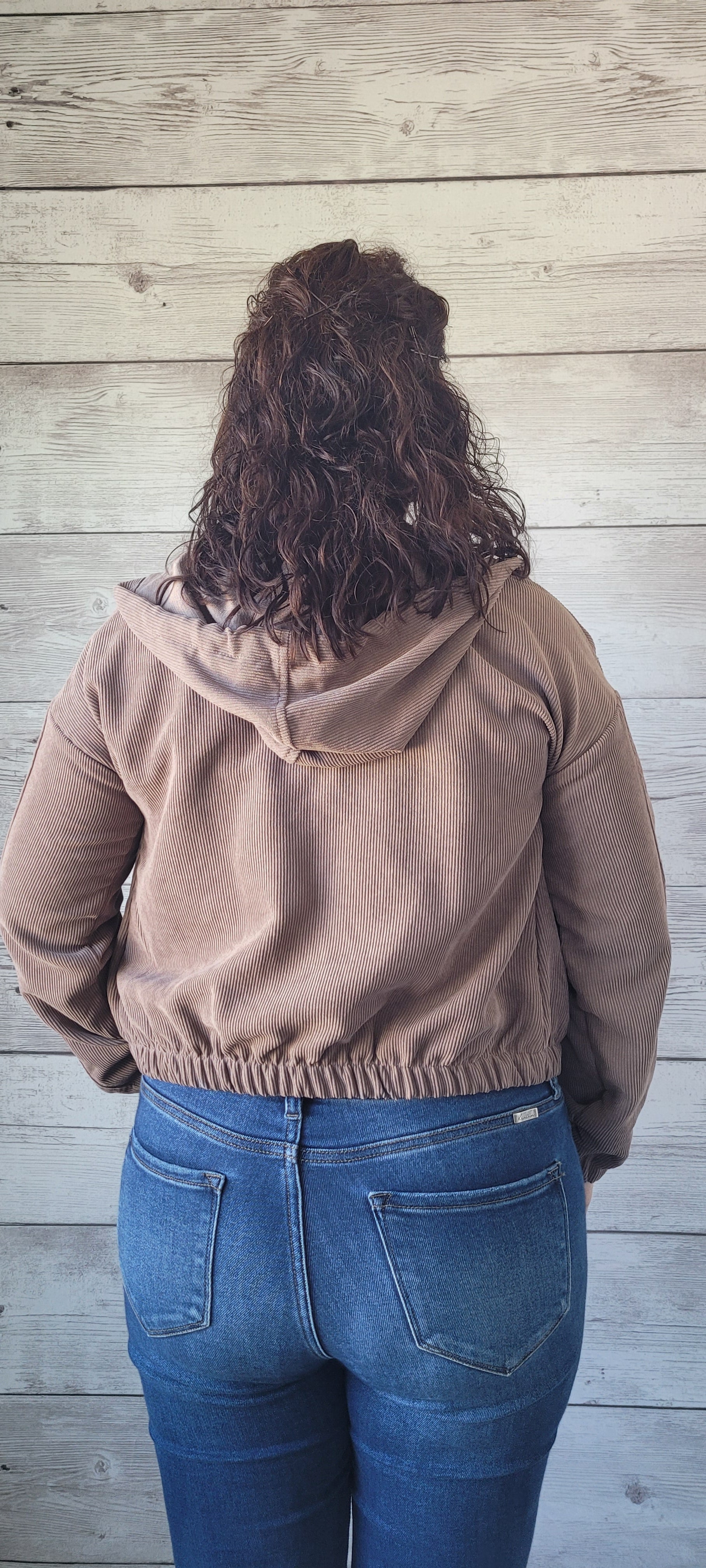 Be cozy and cool with our "Debra Mocha Corduroy Jacket"! With a zipper front, elastic sleeves and waist, plus a hood, you'll be sure to stay warm. Side pockets will keep your hands toasty, and the front tie will keep you looking oh-so-stylish. Cute and comfy?! What more can ya ask for? Sizes small through large.