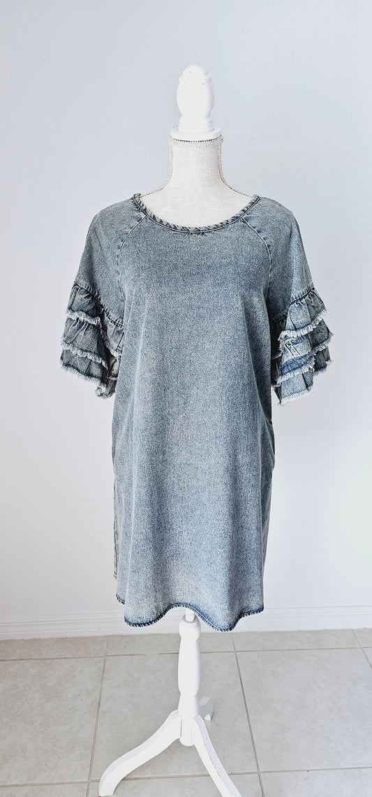This light color denim dress features layered, short sleeves which have ruffles that are fringed/frayed, and comes above the knee. It has two functional pockets. Just slip it on over your head and you are ready to go! Go ahead and strut your stuff! This dress is great for a date, going to the office, or hanging out with the girls. Change the look of your dress by wearing different style belts as an added feature. Sizes small through large.