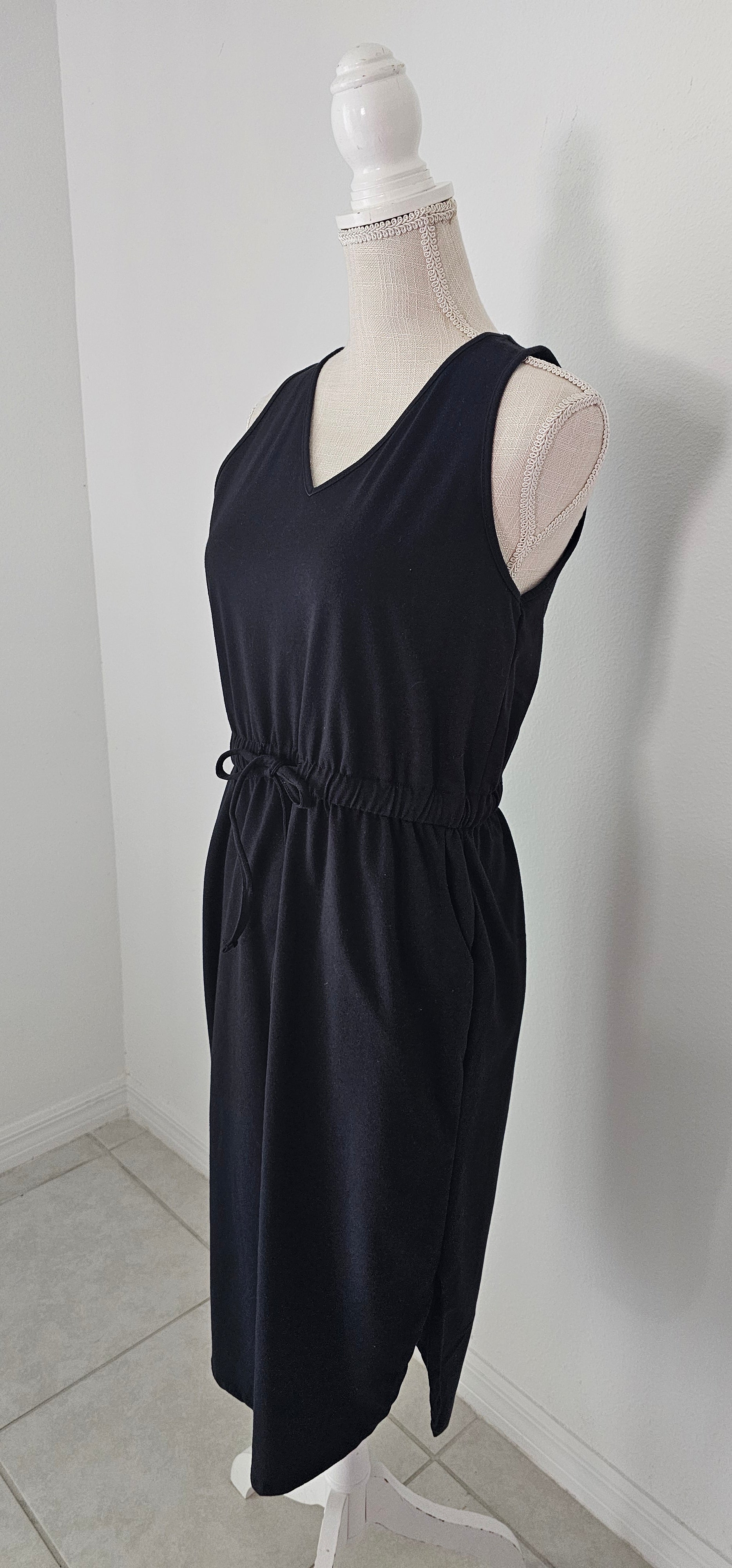 Poly cotton drawstring elastic waist curved hem dress with pockets. Sizes small through x-large.