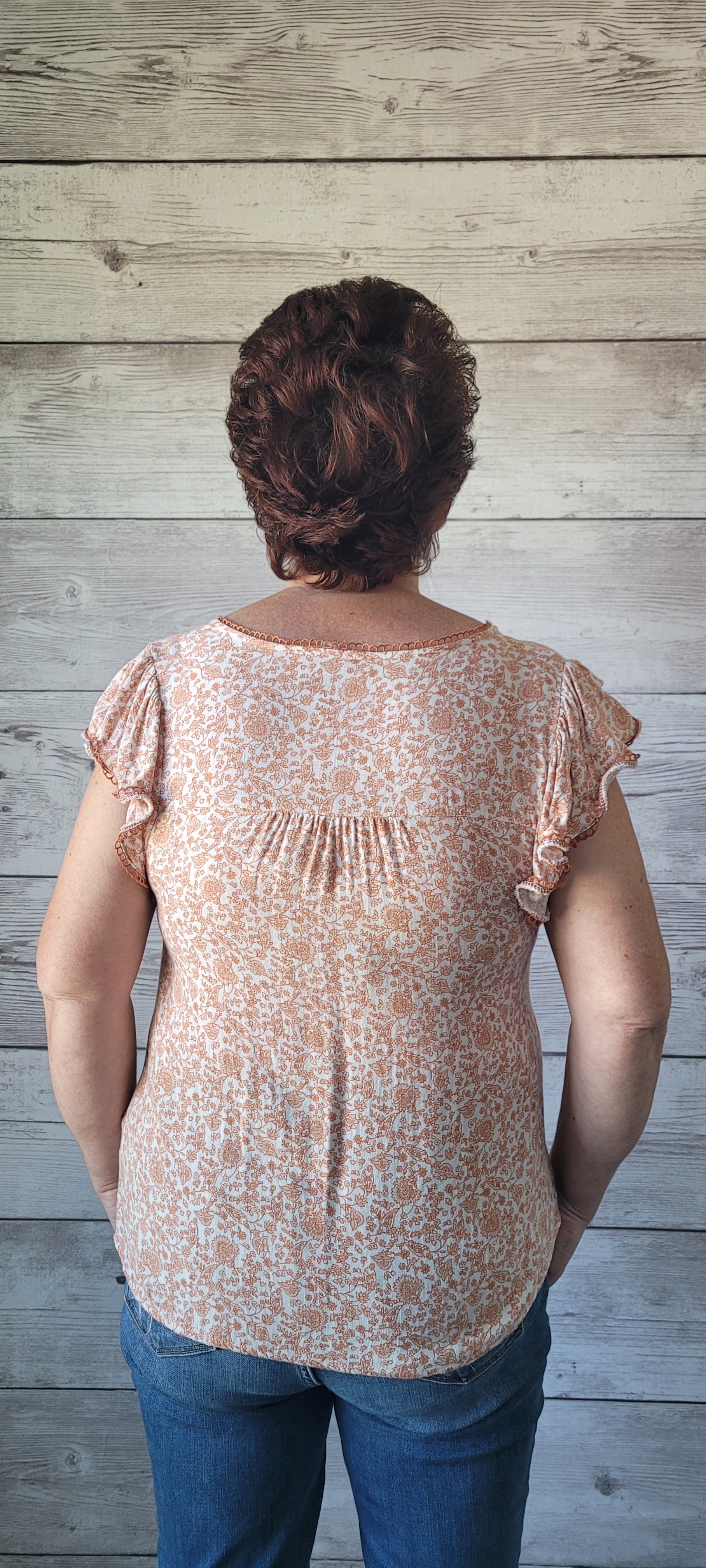 Dress to impress with this soft and dreamy "Tina Dusty Peach" top! With a split round neckline, a front tie with keyhole, flirty short sleeves, and a front chest-line lace, you'll look like you stepped out of a fairy tale. Puttin' the "wow" into every outfit! Sizes small through large.