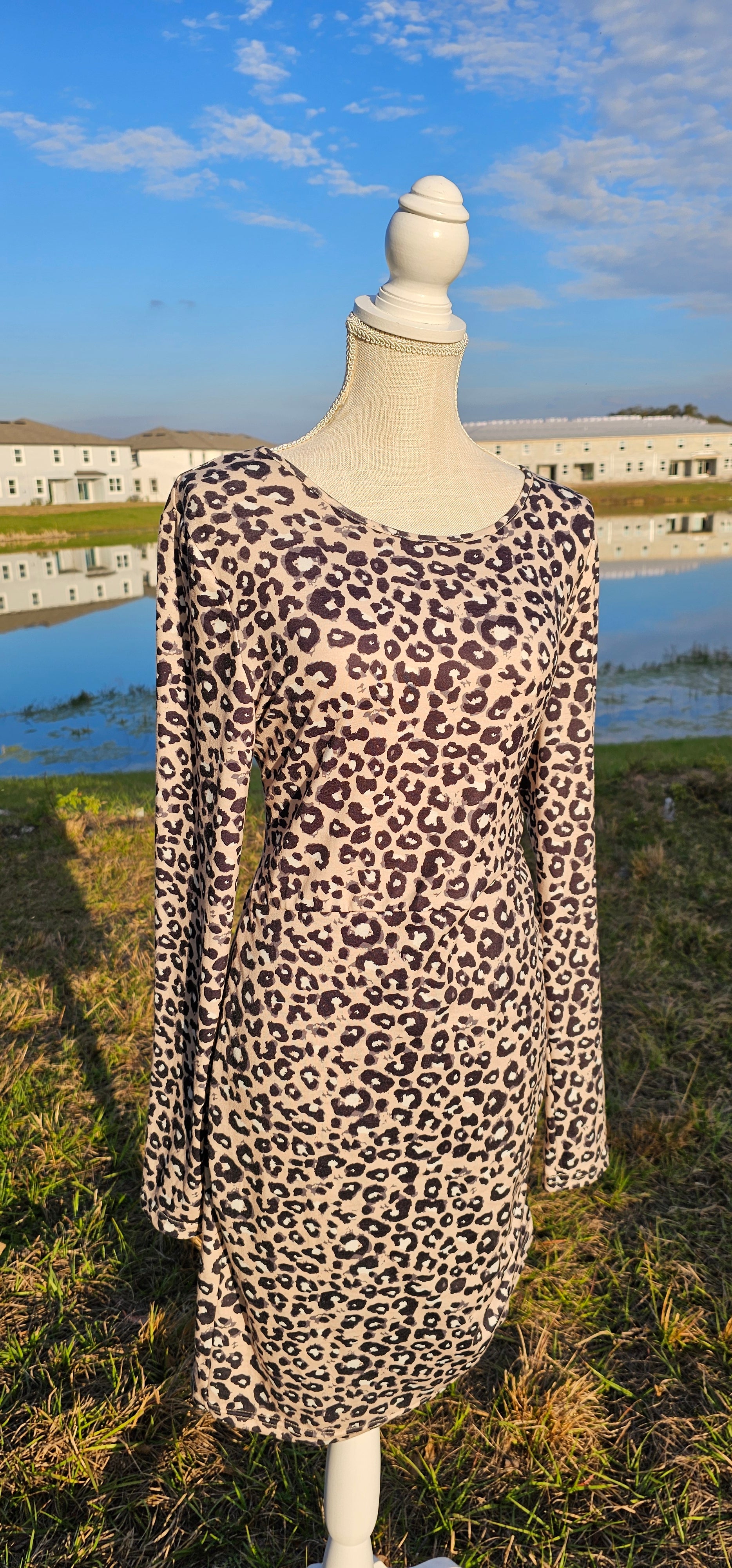Get in touch with your wild side with this taupe, black and white ruched leopard, scoop neck, long sleeve dress. Imagine yourself wearing this cute number to the office, going out on the town, hanging out with family and friends, you will be comfortable whatever you choose to wear your dress to.  Have fun!  Grrrrrrrrrrrrrrrrr! Sizes small through x-large.