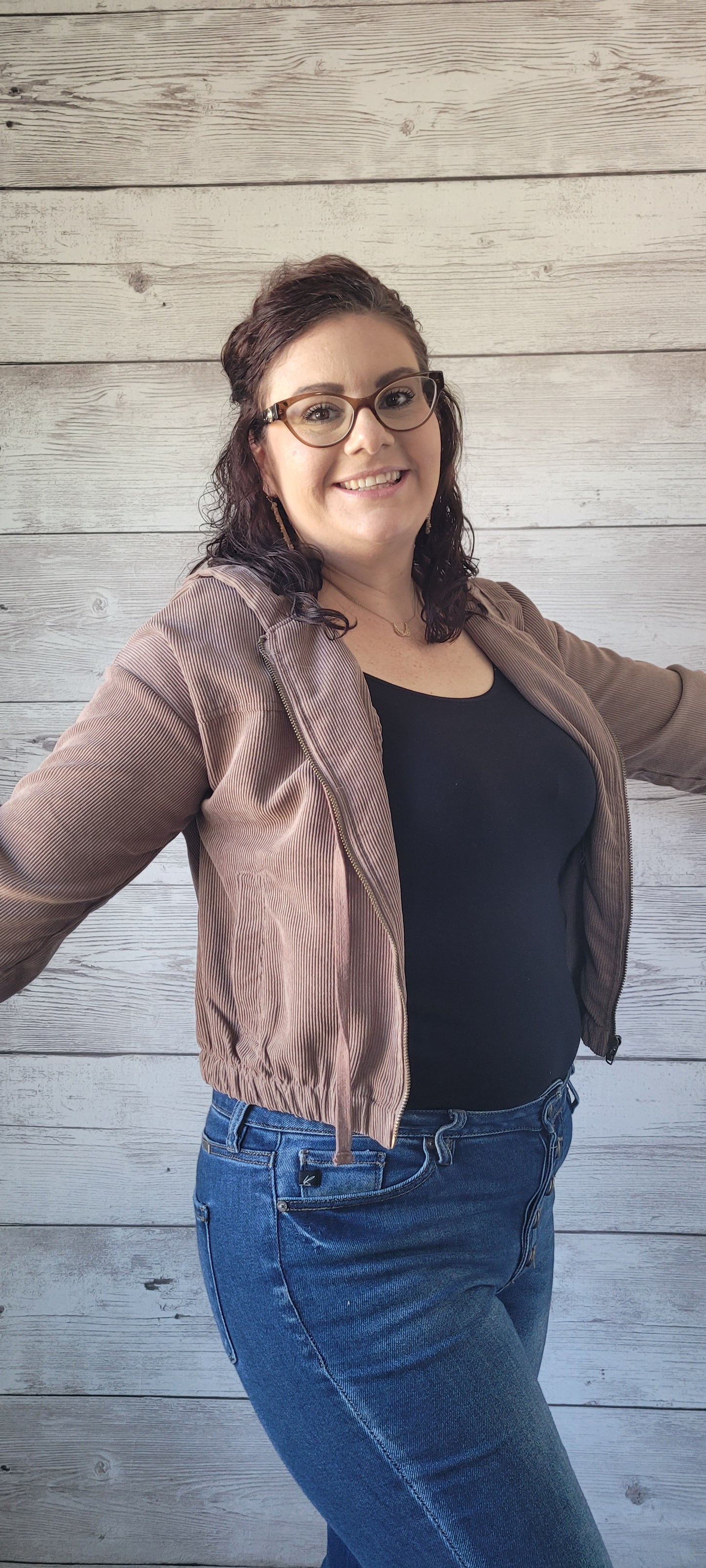 Be cozy and cool with our "Debra Mocha Corduroy Jacket"! With a zipper front, elastic sleeves and waist, plus a hood, you'll be sure to stay warm. Side pockets will keep your hands toasty, and the front tie will keep you looking oh-so-stylish. Cute and comfy?! What more can ya ask for? Sizes small through large.