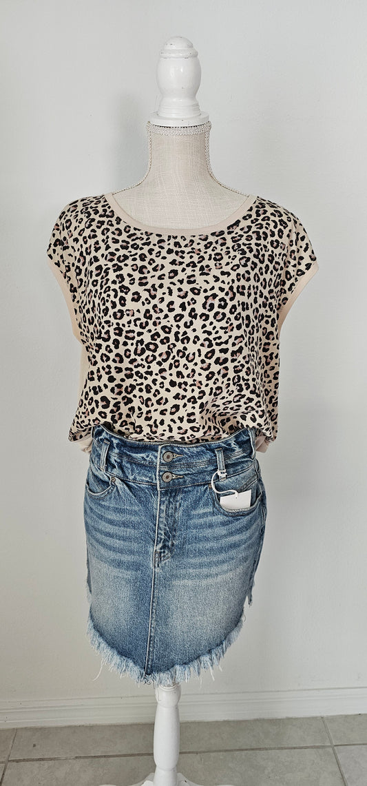 “Road Less Traveled” is a sleeveless top, with leopard print front (beige, brown, camel, agreeable gray) and contrast back, boat neckline, trimmed with beige soft modal, and rounded hemline. This is a satiny, silky soft high-low top. This is definitely a business or casual top. Sizes small through large.