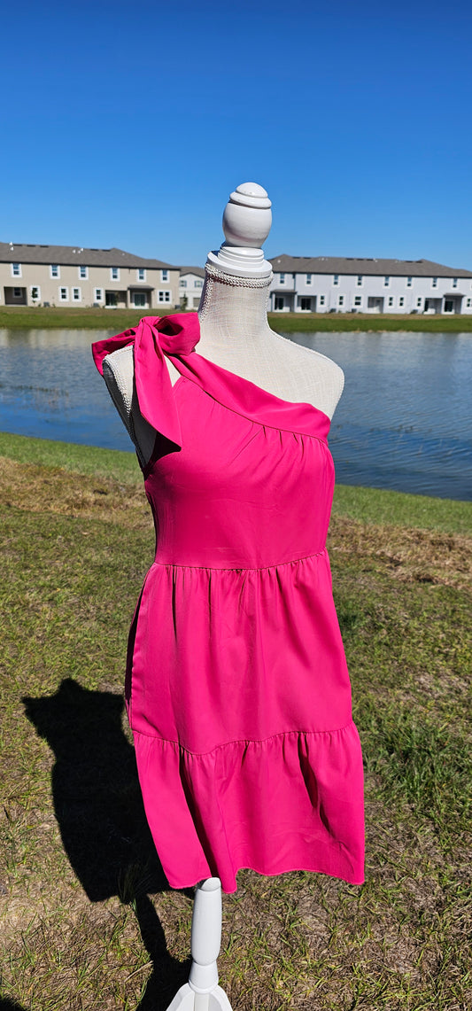 How adorable is this dress! "One Hot Mama" is a sleeveless, one shoulder, fuchsia tiered dress that sits above the knees. This dress features an adjustable bow tie, so you can decide how tight or lose you want it. This dress can be dressed up or casual. This is the perfect date night dress! Sizes small through x-large.