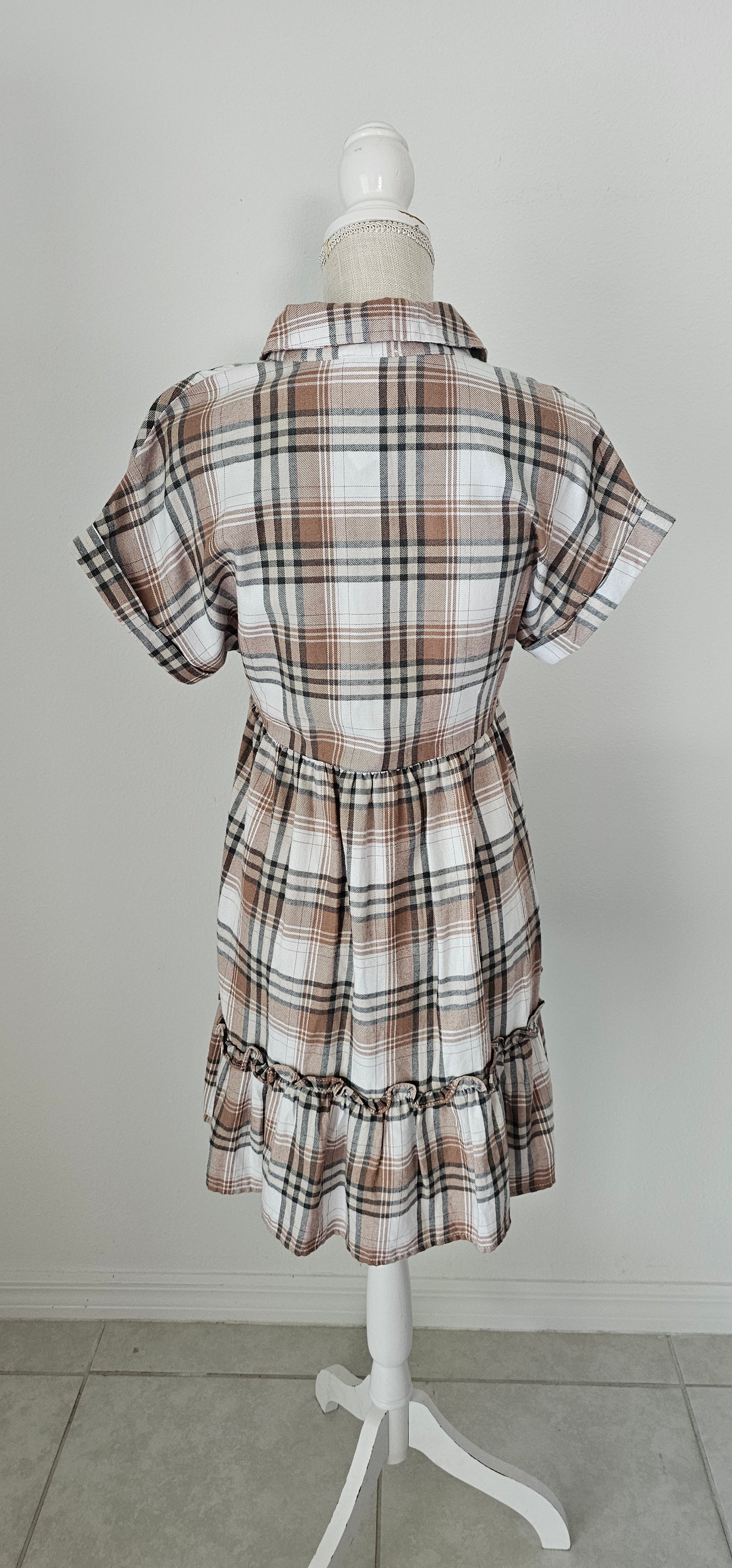 Rock your modern-meets-rustic side in this&nbsp;plaid&nbsp;mini dress! Featuring a collared neckline with button down closure, cinched waist, and a ruffle hem, you'll look fly af (as fashionable) no matter the occasion. With pocket detail, this pleated plaid piece will have you looking cute and stylish all day - yesssss girl! Sizes small through large.