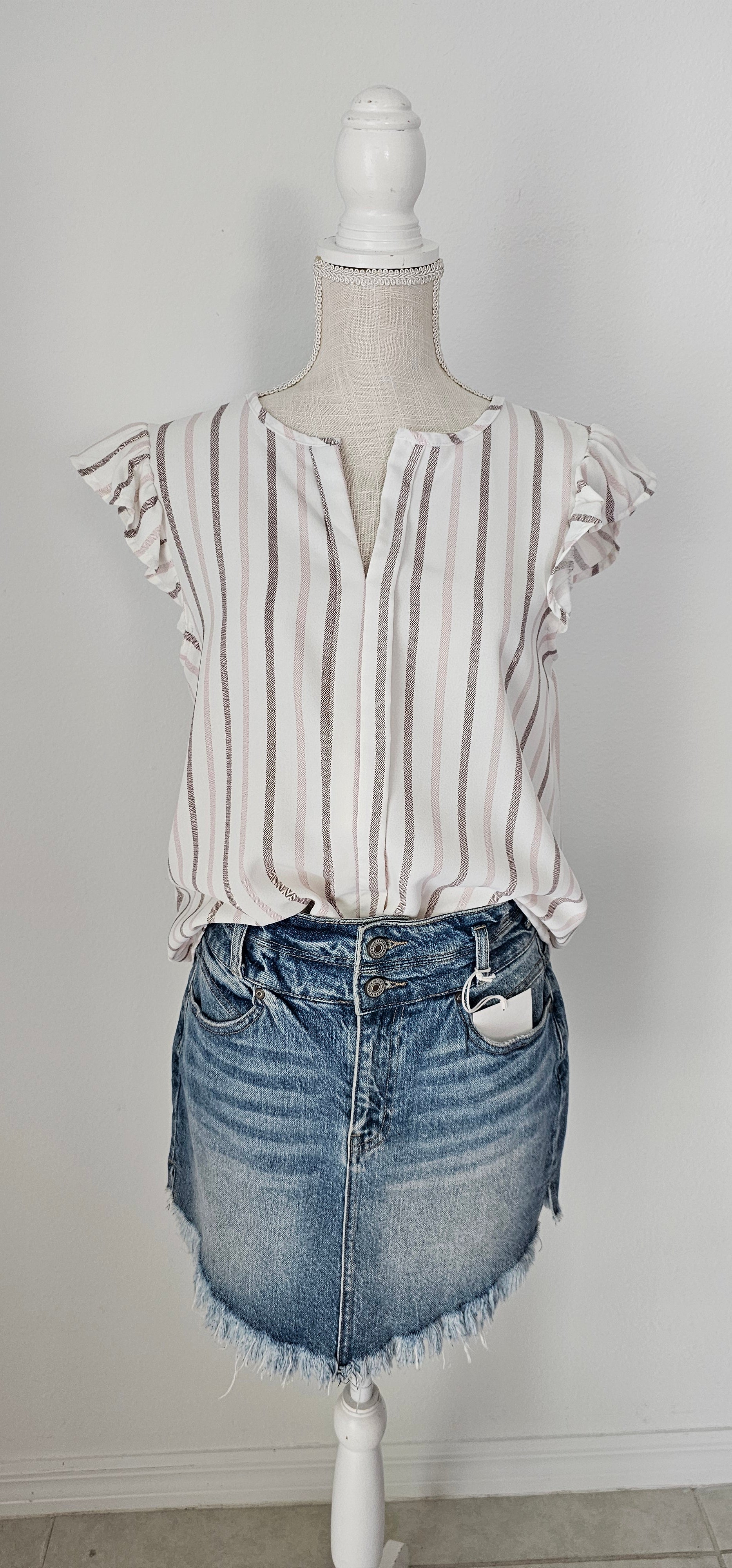 Look as sweet as a summer's day in this "Heather Striped Taupe" top! With cute flutter sleeves, a split round neckline, and a playful front-fold detail, you'll be ready for any outdoor adventure! And just to top it off, the taupe stripes add an extra bit of pizzazz. Who said stripes have to be boring?! Size small through large.