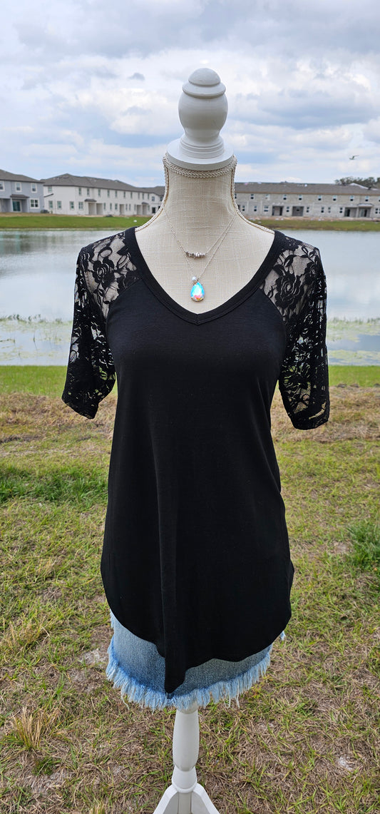 This is a perfect staple for everyday wear. The shirt features a v-neck with lace sleeves. The shirt is a little longer in length, but offers short sleeves. Imagine yourself wearing this shirt alone or with a sweater over the top of it.  This shirt is so versatile. That’s what makes this a great purchase. You can't go wrong! Sizes small through x-large.