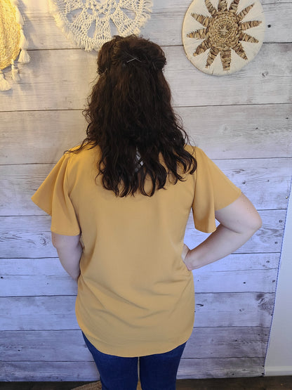 Harvest some style in this Dandelion Fields Golden Mustard Top! Featuring a woven flutter sleeve v-neck - it's the perfect outfit choice to spice up any look! Guaranteed to make you stand out like a ray of sunshine. Sizes small through x-large.