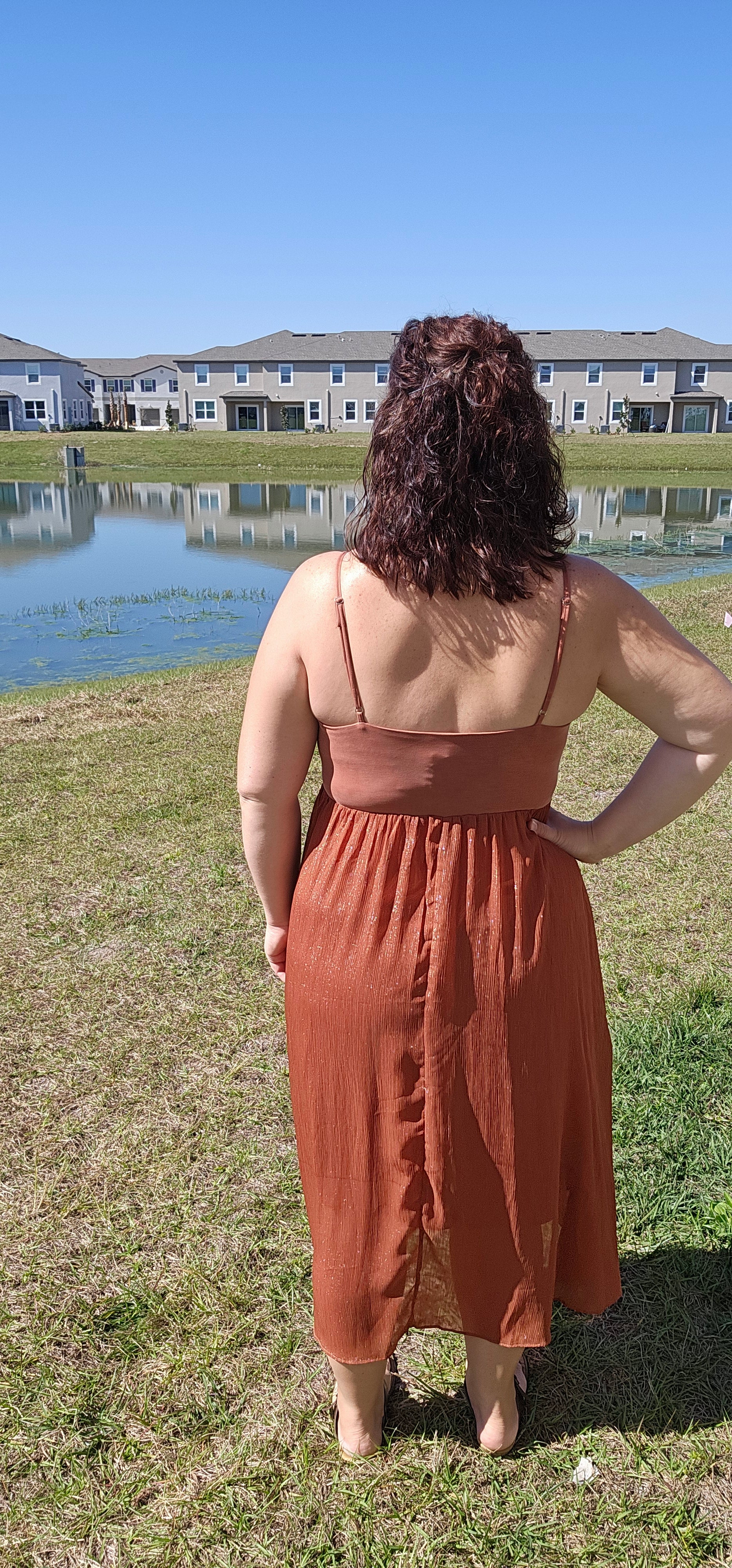 Look stunning and stay comfortable in the "Inaya Rust Modal Cami Midi Dress" with a hint of shimmer! With its adjustable shoulder strap and airy open back, this dress offers the perfect mix of style and breathability. And with a rayon lining, you can strut your stuff in divine comfort and style. You'll want to wear it everywhere! Sizes small through large.