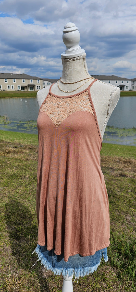 This tank is a must have! It is simple and basic. It is easy for layering or great all by itself! The tank is a relaxed fit, featuring a crocheted floral rounded neckline, curved hemline, and fixed non-adjustable straps. Color is ash mocha. Pair with your favorite denim jeans, tucking the corner of the tank into your belt loop or dress it up with an edgy skirt. Don’t be afraid to get creative! Sizes small through x-large