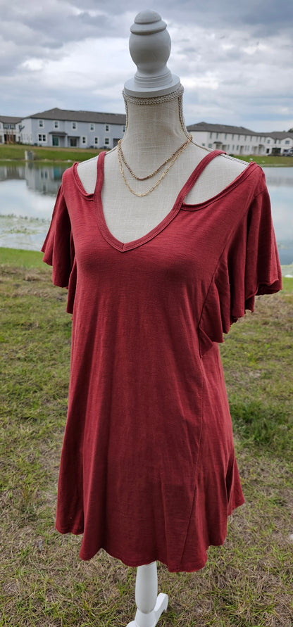 You will look so cute in this off the shoulder dress, featuring spaghetti straps, ruffled sleeves, and exposed raw hem.  This dress comes above your knee, and has a scoop front and a scoop back neckline. Sizes small through large.