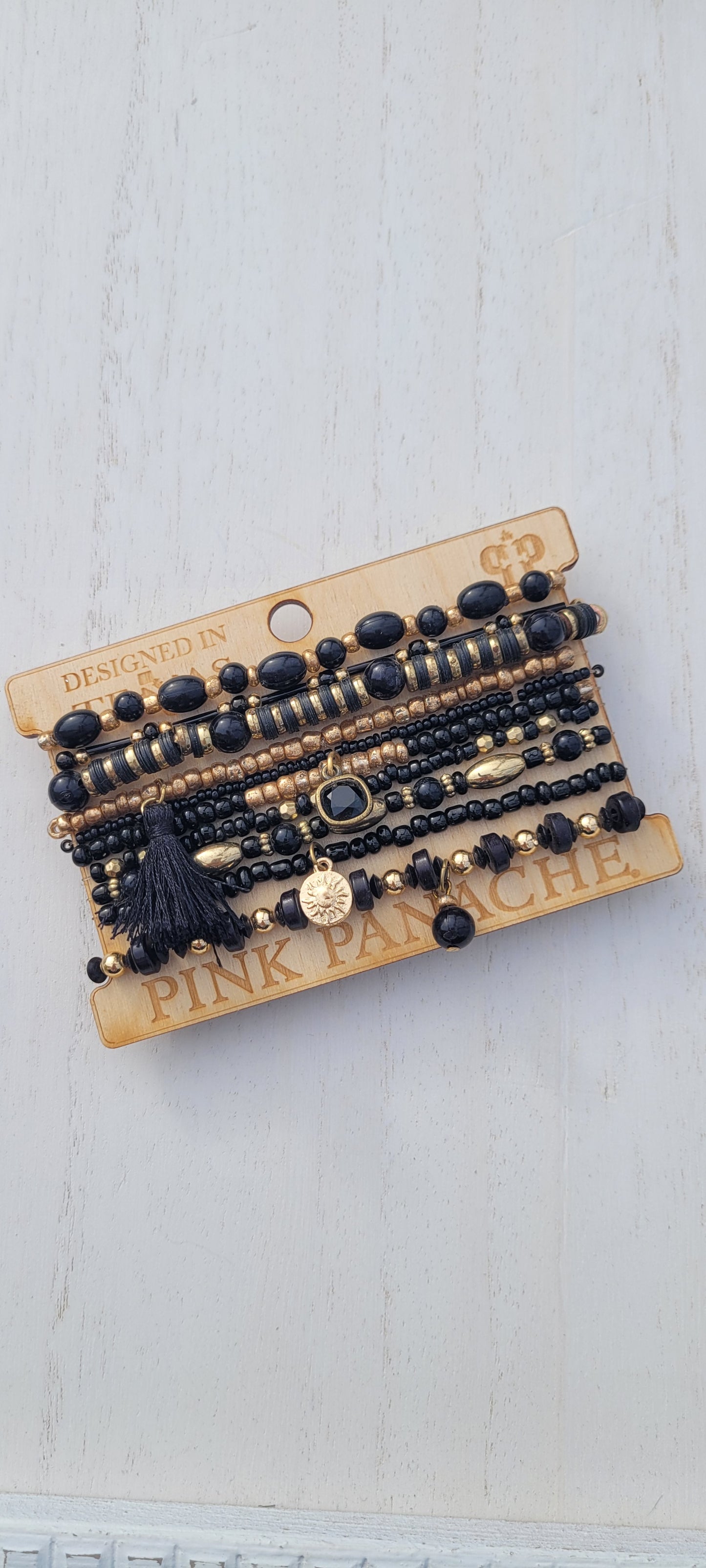 Pink Panache bracelet 10-strand black mix bead curvy bracelet with 8mm bronze/black cushion cut drop and tassel Limited supply!