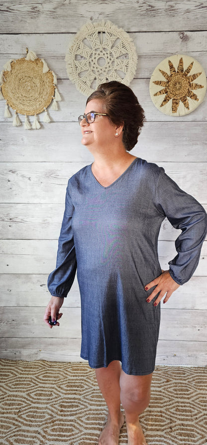 Imagine yourself in this dress going to the rodeo, line dancing, a party, or just hanging out with family and friends. This denim look dress offers a V-neck,&nbsp; and long sleeves that are cinched at the wrist. This dress is very comfy as it has a lot of give and is roomy. Sizes small through x-large.