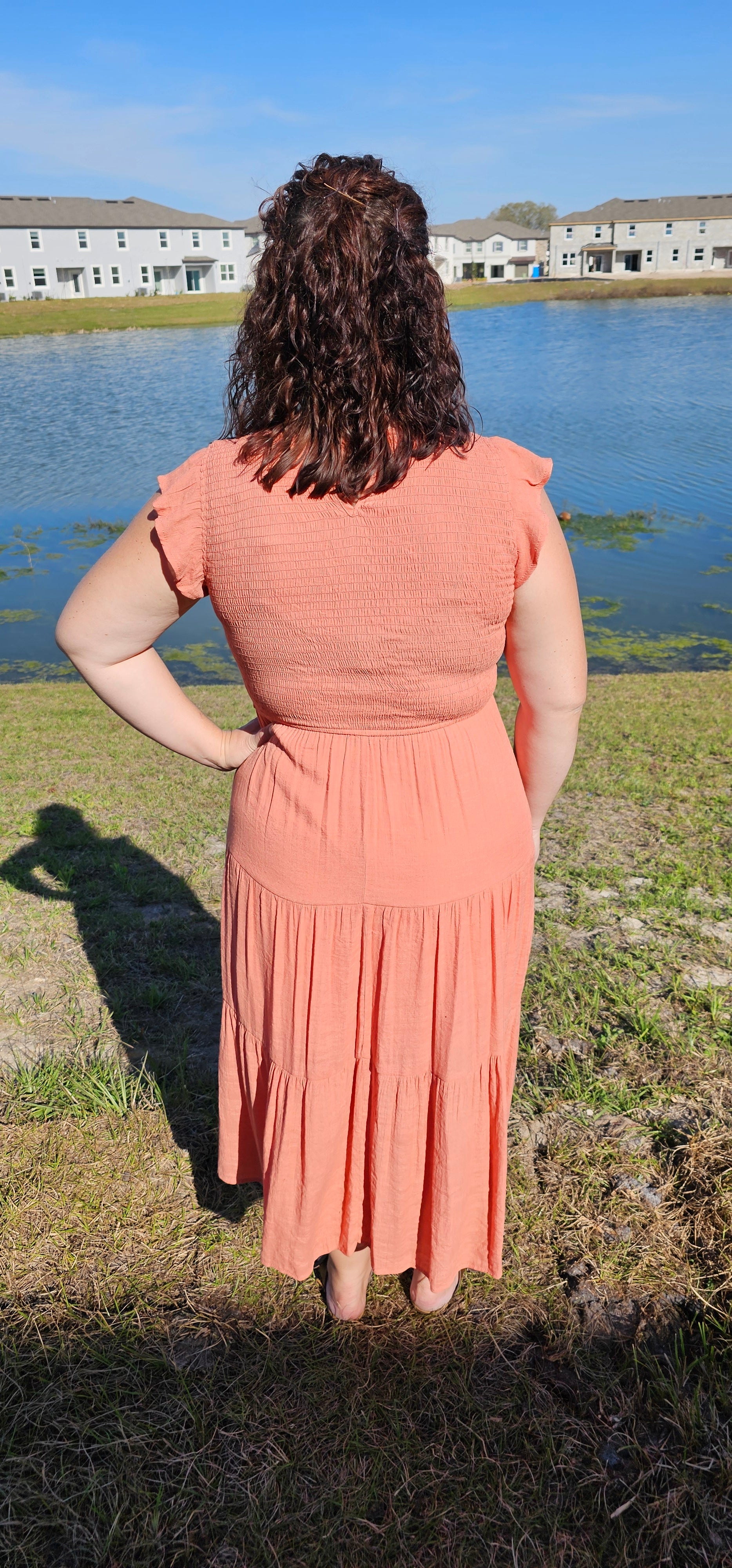 This dress is ready to charm your day away! Flattering round neckline, keyhole-secured back neck button, and fluttery short cap sleeves combine with smocked body and tiered skirt for an oh-so-sweet silhouette. You'll be saying 'till tomorrow' in this cozy, lined midi dress! Sizes small through large.