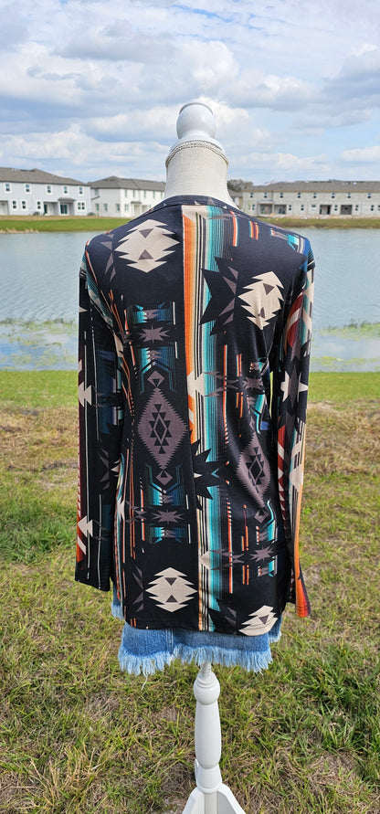 This is a comfy and casual long sleeve top. It features a rounded neckline with a V shaped cutout, long sleeves, Aztec design.  Imagine yourself going to the rodeo, or line dancing.  Whatever your adventure is, this is the shirt! Sizes small through x-large.