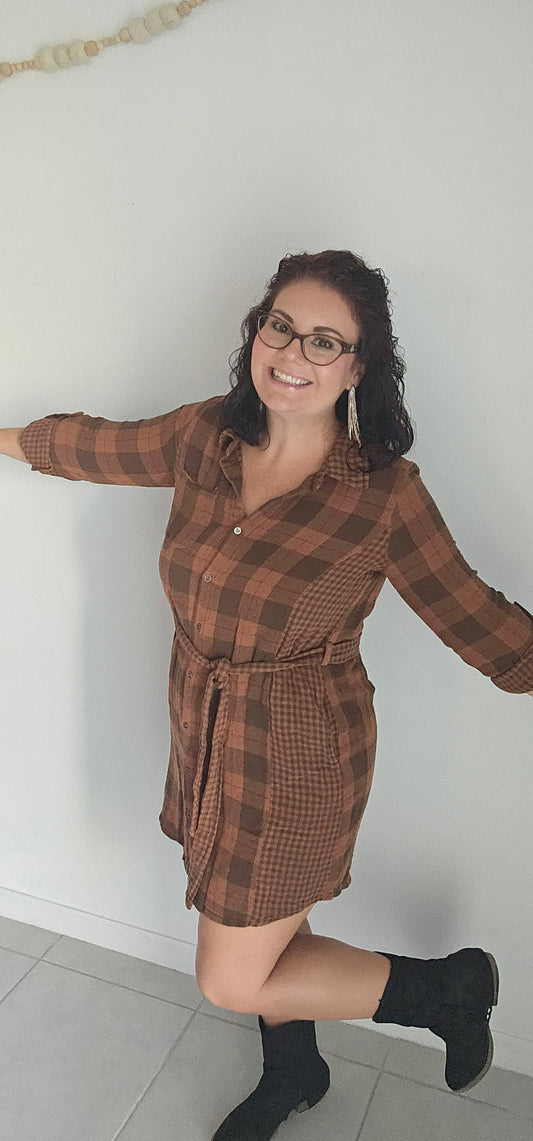 Step into autumn in style with the Riley Rust Plaid Shirt Dress! This warm plaid dress has all the details that make it a stand-out: buttoned front, tie-waist belt, plus functional chest and side pockets. Roll up the sleeves and get ready to kick up some fallen leaves. It's sure to get you noticed! Sizes small through large.