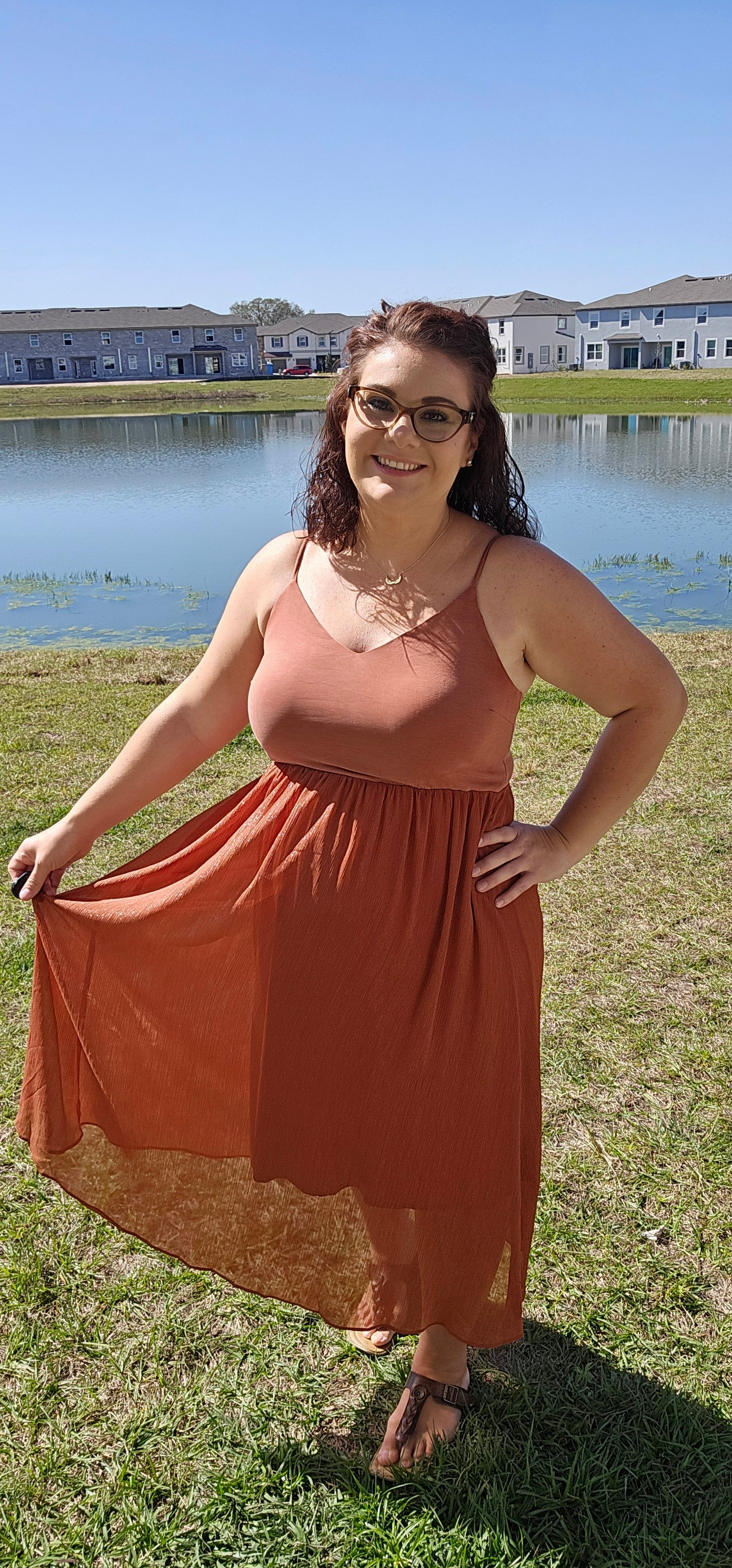 Look stunning and stay comfortable in the "Inaya Rust Modal Cami Midi Dress" with a hint of shimmer! With its adjustable shoulder strap and airy open back, this dress offers the perfect mix of style and breathability. And with a rayon lining, you can strut your stuff in divine comfort and style. You'll want to wear it everywhere! Sizes small through large.