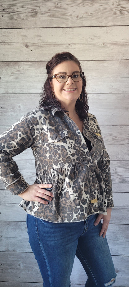Go wild in our stunning "Felicia" jacket! This cozy-yet-chic piece is designed with a fierce leopard print, bust pockets, and metal buttons on the front closure to give your look some serious attitude. Button cuff long sleeve keeps you looking cool, while the peplum shaping gives you a flattering finish. Suit up and show the world who's boss! Sizes small through large.