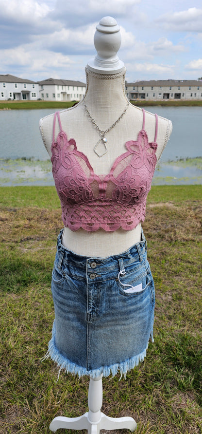 This bralette is a must have staple piece! It is easy for layering or great all by itself! This bralette is super comfy and can easily replace your current bra. No need to worry about clasps, this bralette easily slips over your head. It also features a floral crochet lace, ruched stretchy back, four adjustable straps with crisscross detail in back, and removable bra pads. Color is dusty rose. Pair with your favorite jacket or off the shoulder sweater. Sizes small through x-large.