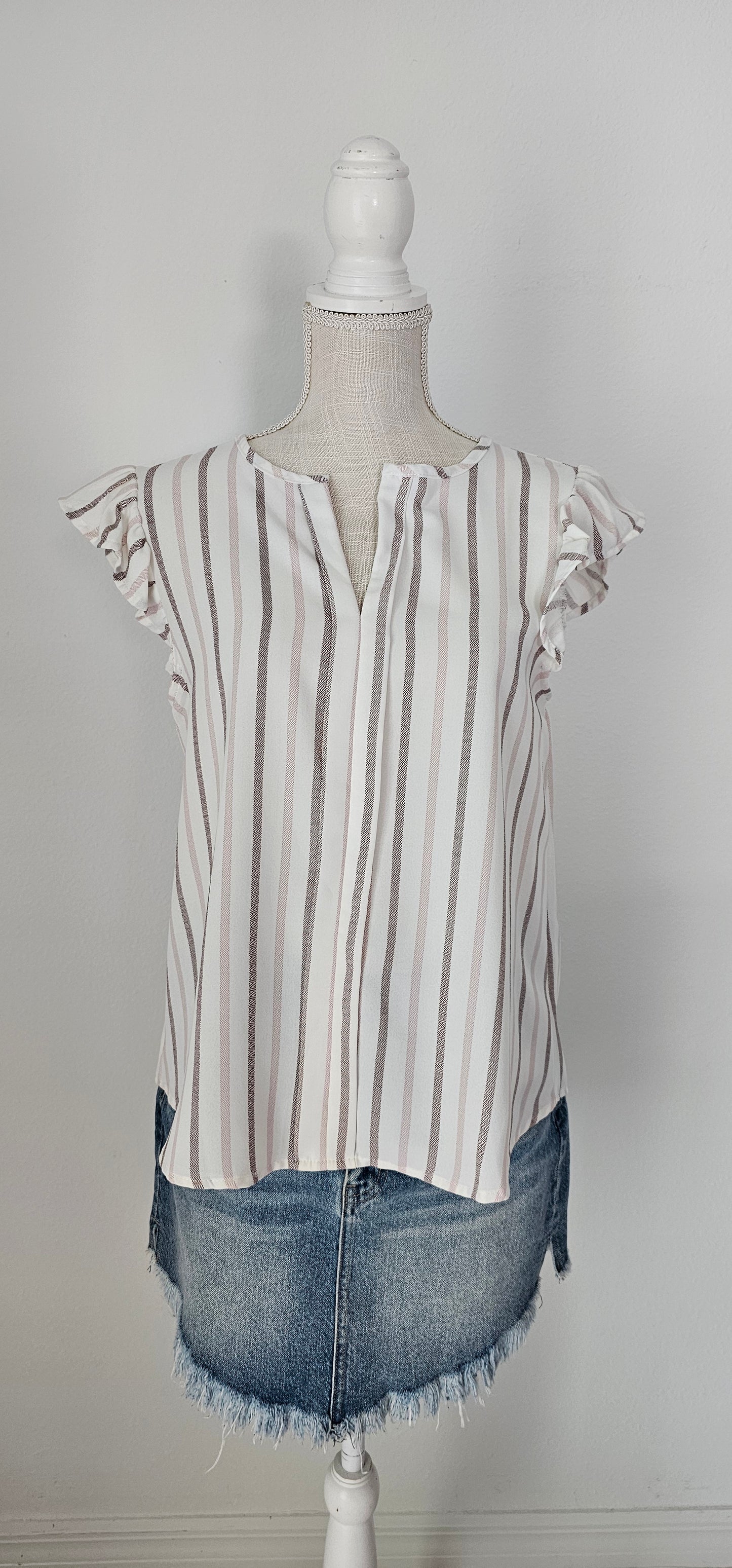 Look as sweet as a summer's day in this "Heather Striped Taupe" top! With cute flutter sleeves, a split round neckline, and a playful front-fold detail, you'll be ready for any outdoor adventure! And just to top it off, the taupe stripes add an extra bit of pizzazz. Who said stripes have to be boring?! Size small through large.