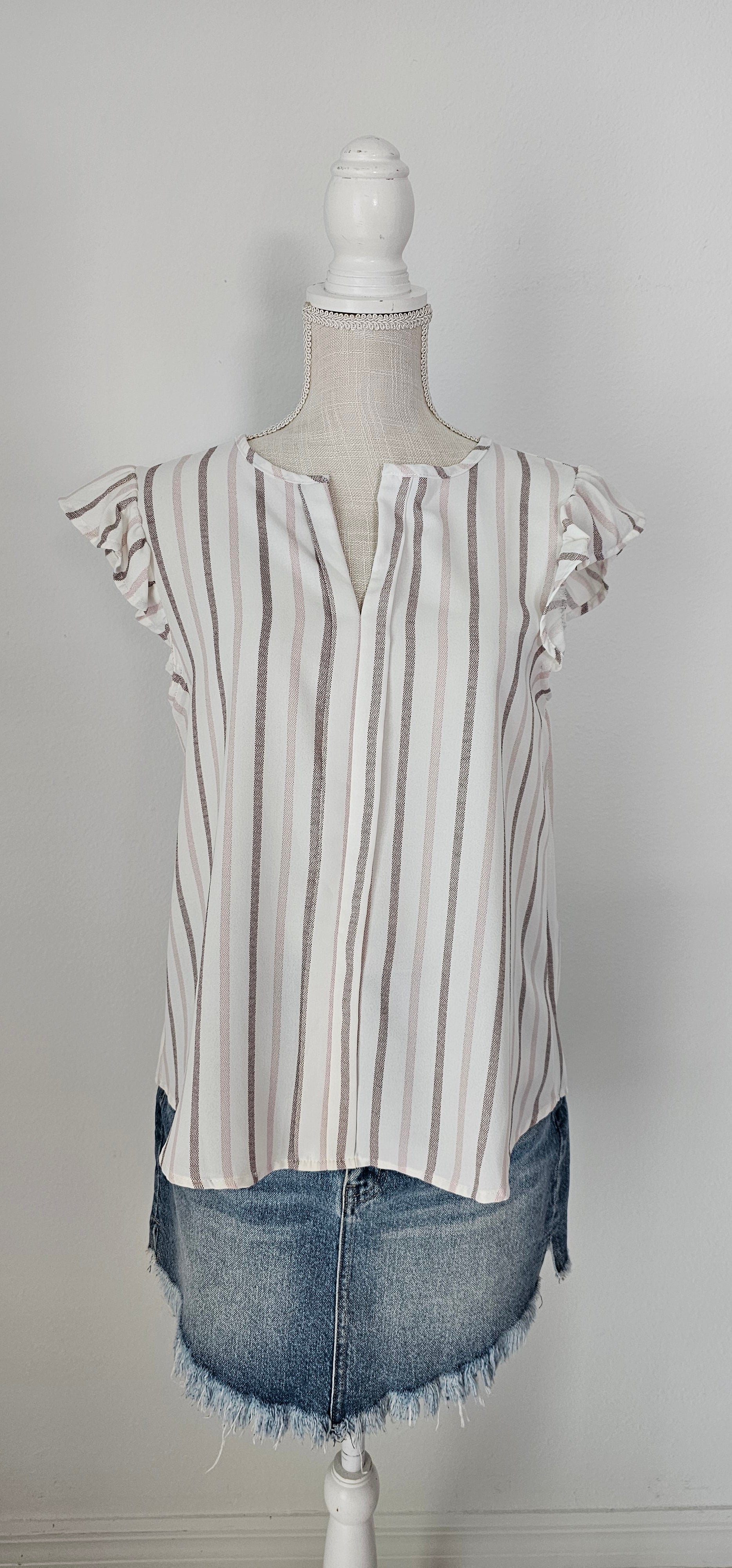 Look as sweet as a summer's day in this "Heather Striped Taupe" top! With cute flutter sleeves, a split round neckline, and a playful front-fold detail, you'll be ready for any outdoor adventure! And just to top it off, the taupe stripes add an extra bit of pizzazz. Who said stripes have to be boring?! Size small through large.