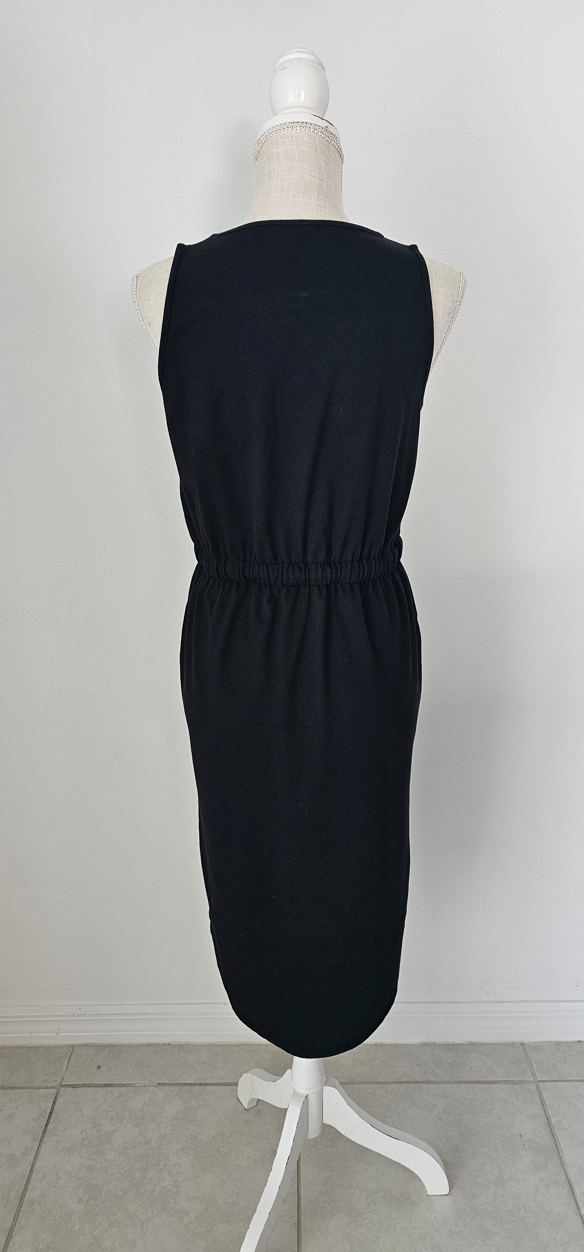 Poly cotton drawstring elastic waist curved hem dress with pockets. Sizes small through x-large.