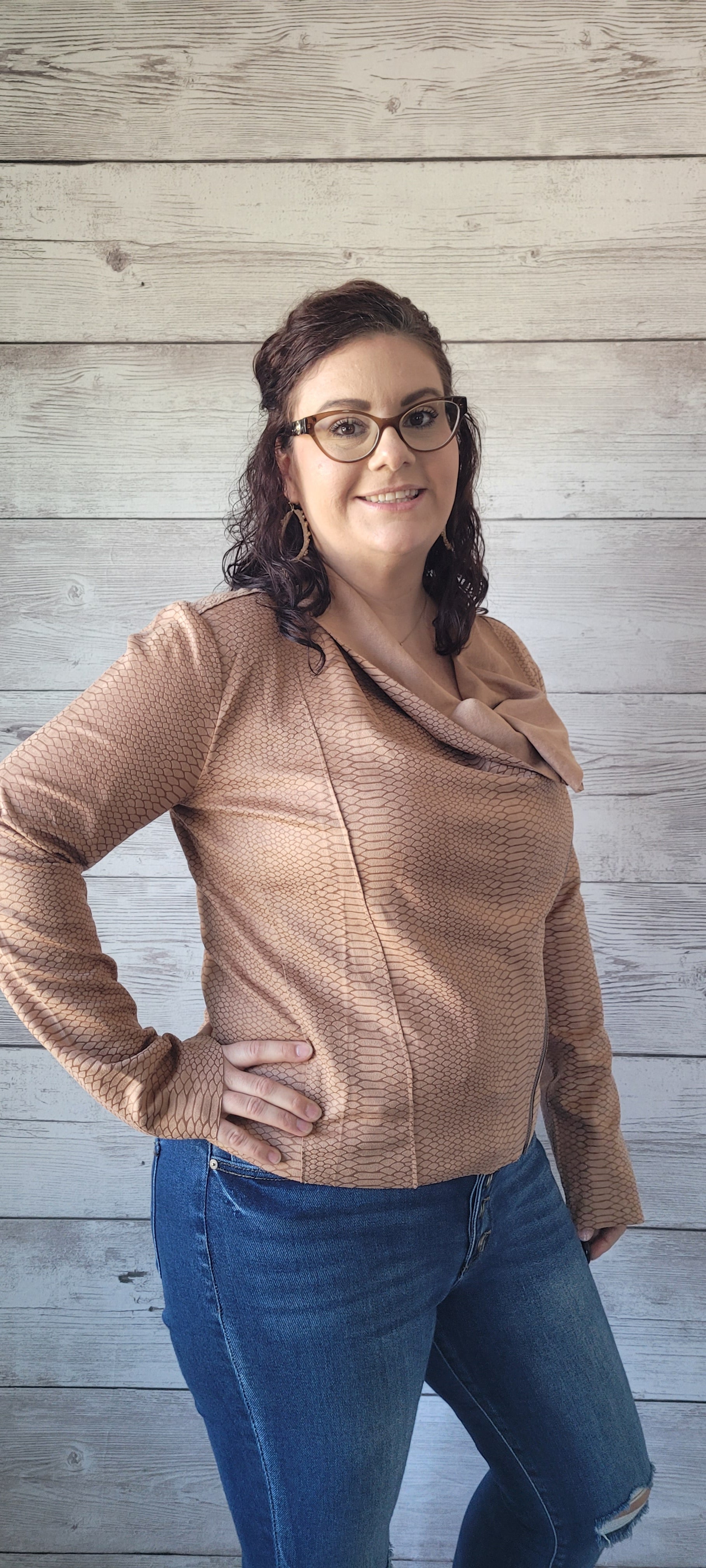 Introducing the "Athena Camel Snake Print Faux Suede Jacket"! It's lightweight and features an asymmetrical collar, so you can make a statement with your layering game. Plus, the snake print and zip-down style help you slither into fashion-forward styling. Unleash your wild side in this faux suede jacket! Sizes small through large.