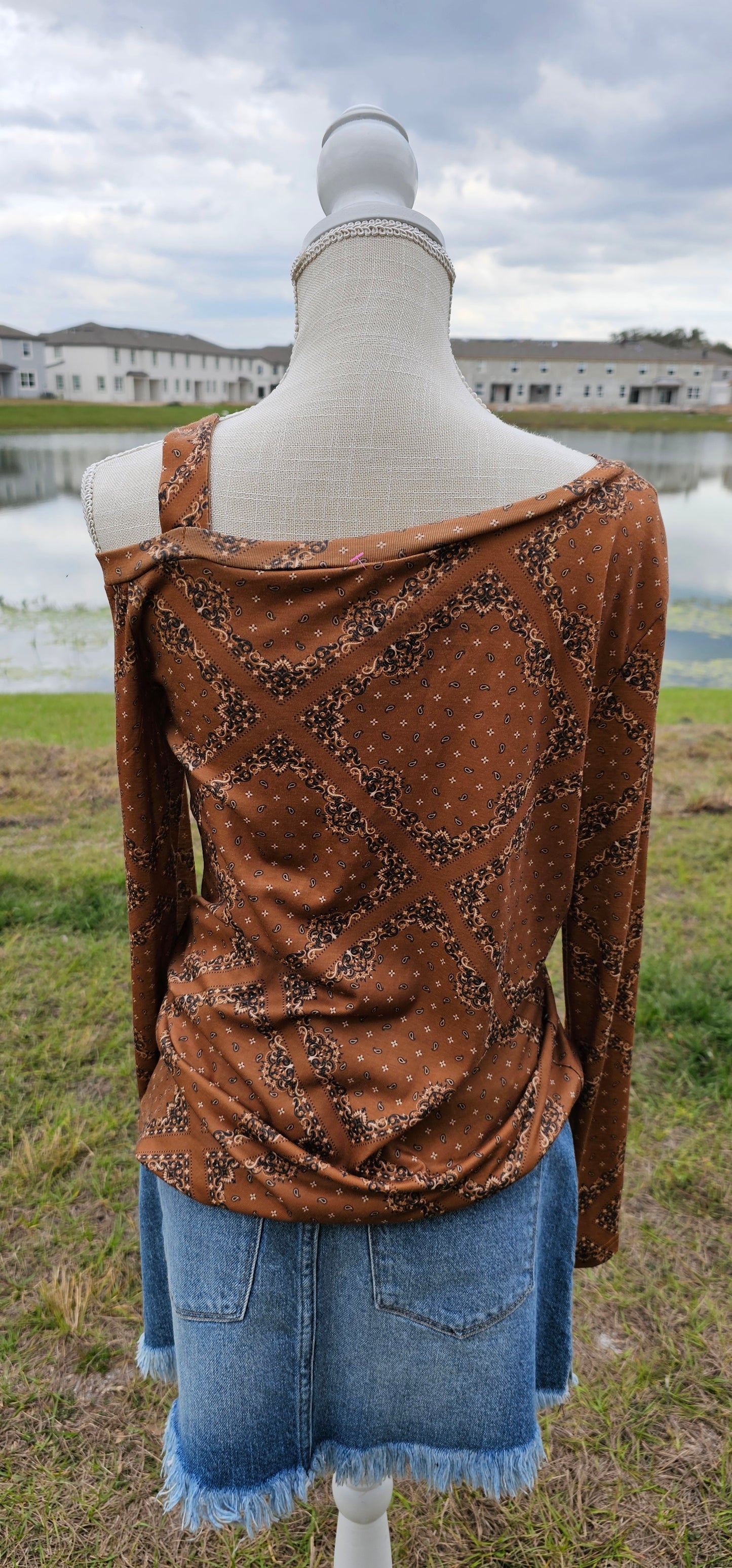 This top features one cold shoulder with strap, long sleeves, with bandana print.  Light weight and breathable. Go ahead and wear it line dancing, to the rodeo, hanging out with your friends, or just running errands.  You know that you want to give it a try! Sizes small through x-large.