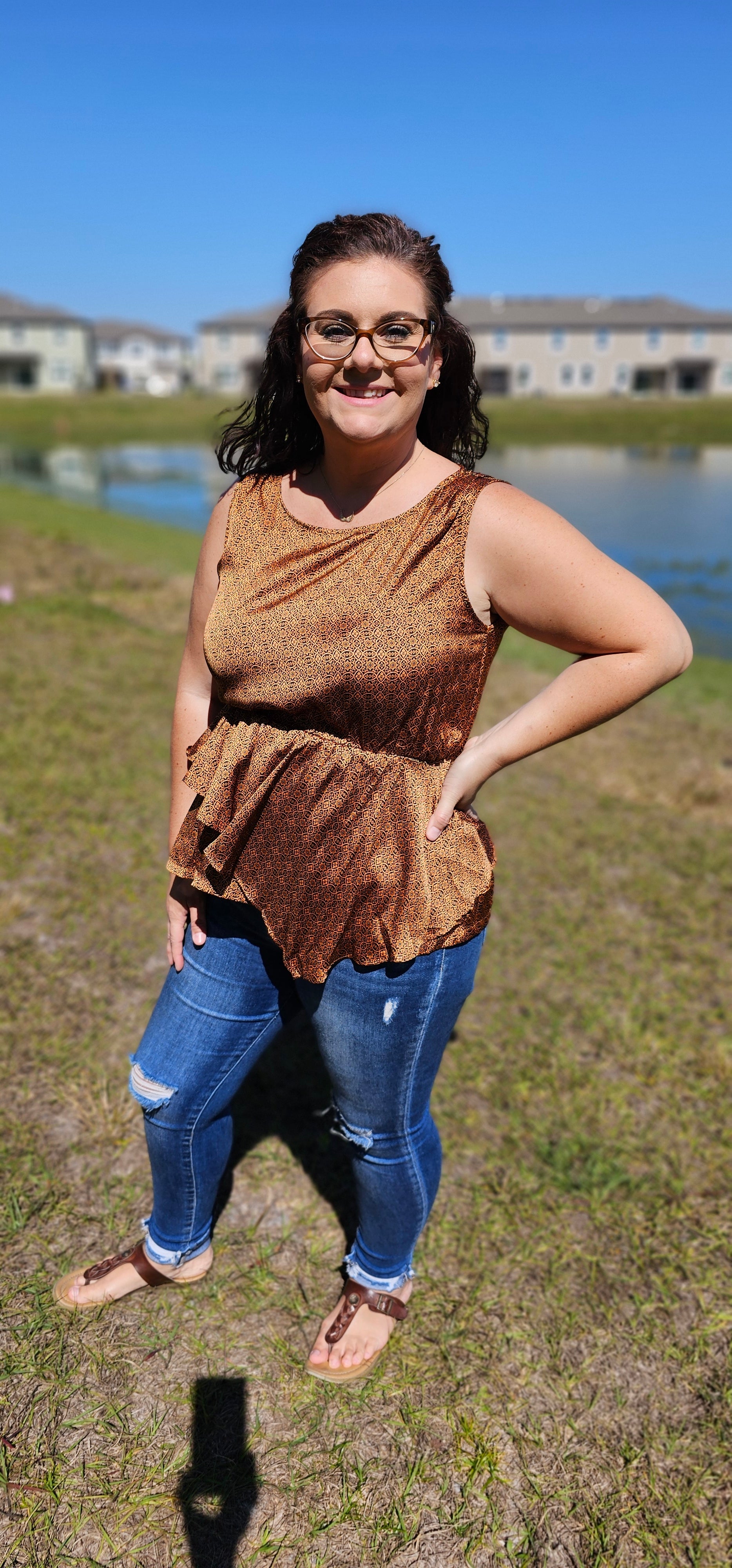 Show off your wild west style with this fashionably rustic "Merida" top! Featuring a beautiful silky satin fabric, an asymmetrical ruffle bottom, an elastic waist, and a keyhole back, you'll be riding off into the sunset in no time! Yee-haw! Sizes small through large.