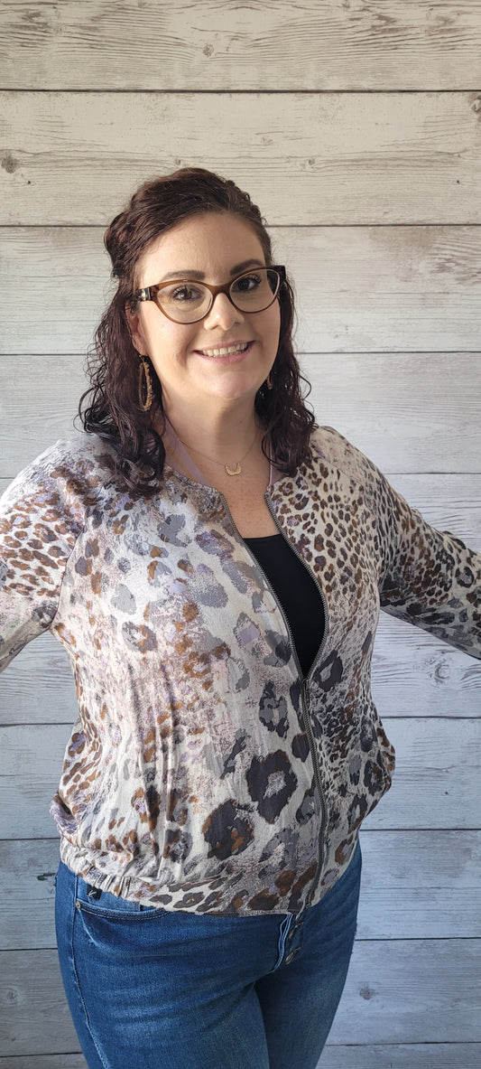 “Feeling Fabulous” is a lightweight leopard print bomber jacket. This jacket features a zip up front, two functional side pockets, ribbed collar, elastic cuffs and waistband. The colors are mauve, light and dark gray, and camel. Sizes small through large.