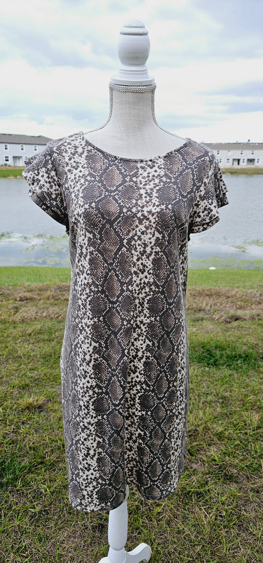 “Live In The Moment” is a snake print, waffle knit dress featuring ruffled layer sleeves, rounded neckline, and it sits above the knees. It is a soft, breathable material. This is unlined, non-sheer, and lightweight. This dress is cream and various browns. Sizes small through large.
