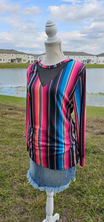 Imagine yourself in this  long sleeve bright colored top that has a black mesh V cut-out.  The sleeves offer a cuff for that nice fit. The bright colors really make this top pop. Going to the rodeo, line dancing, hanging out with family and friends, or just because, this top will be a great addition to your wardrobe. Sizes small through x-large.