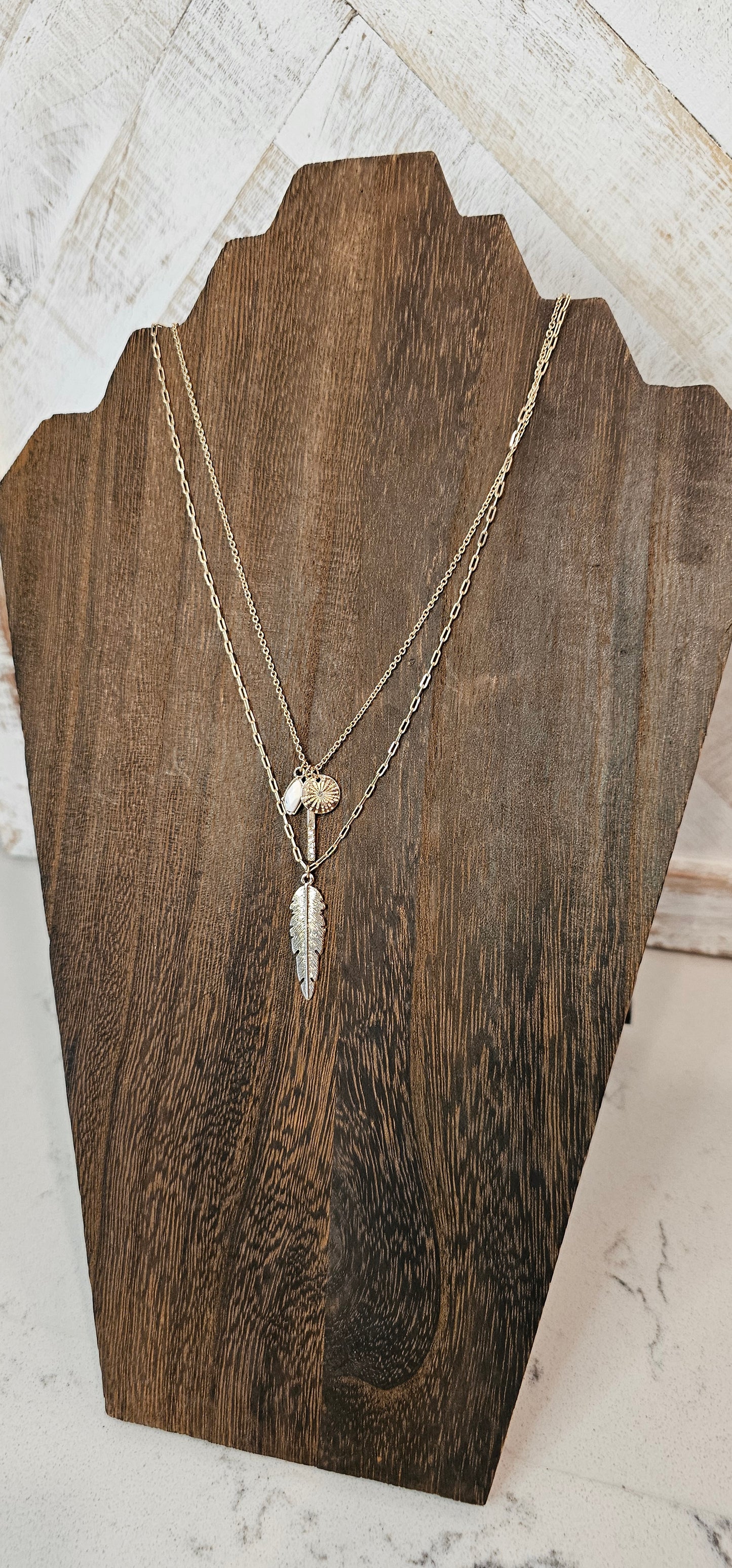Approximate Length: Adjustable chain 16+2 inches Color: Gold link chain with feather, sun, bar with crystals pendants and small stone Limited supply!  
