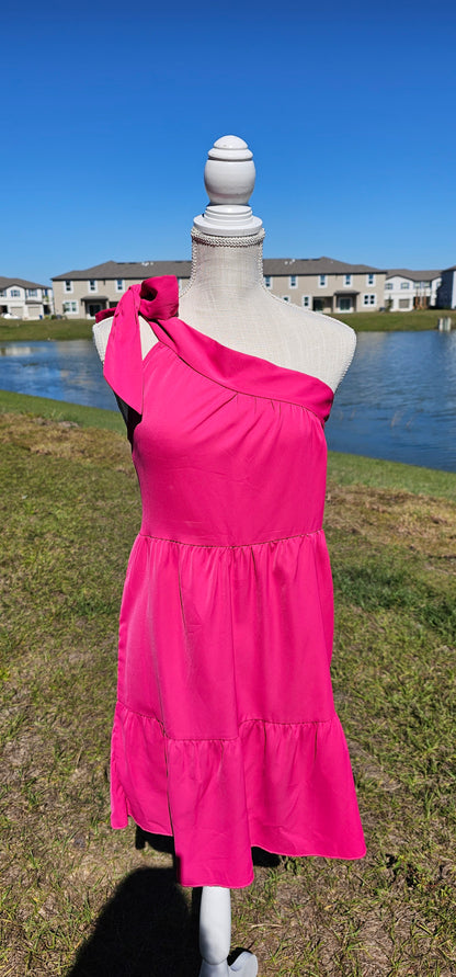 How adorable is this dress! "One Hot Mama" is a sleeveless, one shoulder, fuchsia tiered dress that sits above the knees. This dress features an adjustable bow tie, so you can decide how tight or lose you want it. This dress can be dressed up or casual. This is the perfect date night dress! Sizes small through x-large.