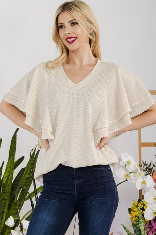 The V-Neck Lace Trim Flutter Sleeve Top is a feminine and elegant addition to your wardrobe. The delicate lace trim adds a touch of romance to the top, while the flutter sleeves bring a whimsical and airy feel.  S-3X
