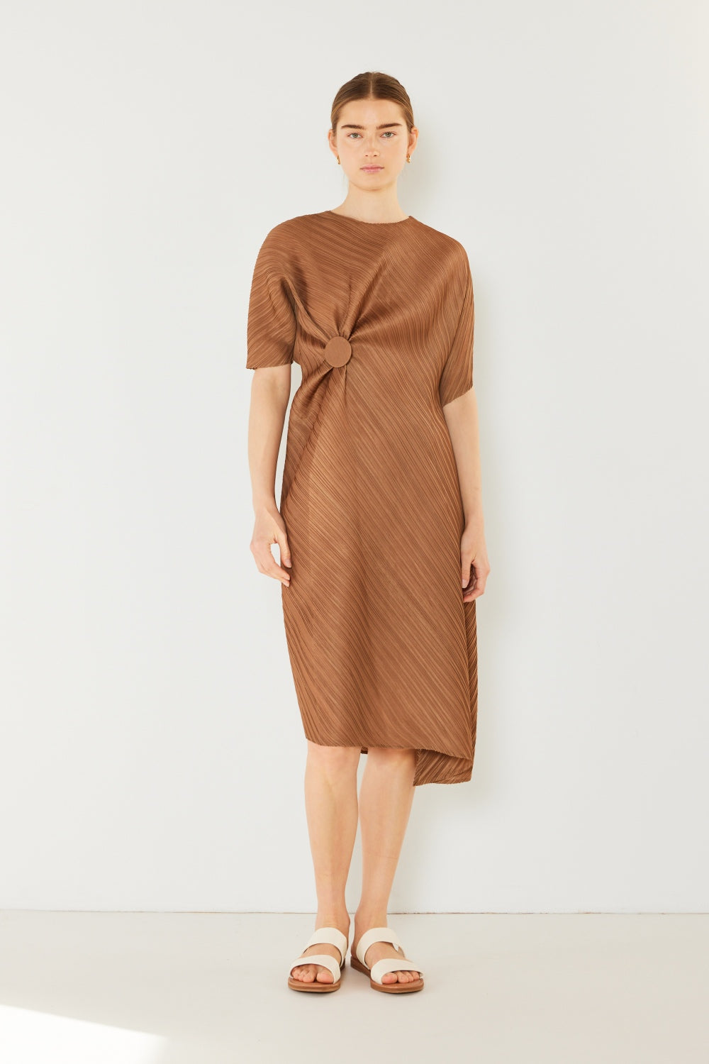 The Pleated Dolman Sleeve Dress is a modern and chic addition to your wardrobe. With its unique dolman sleeves and pleated detailing, this dress offers a stylish and sophisticated look. The relaxed silhouette and pleats create a flattering and comfortable fit.