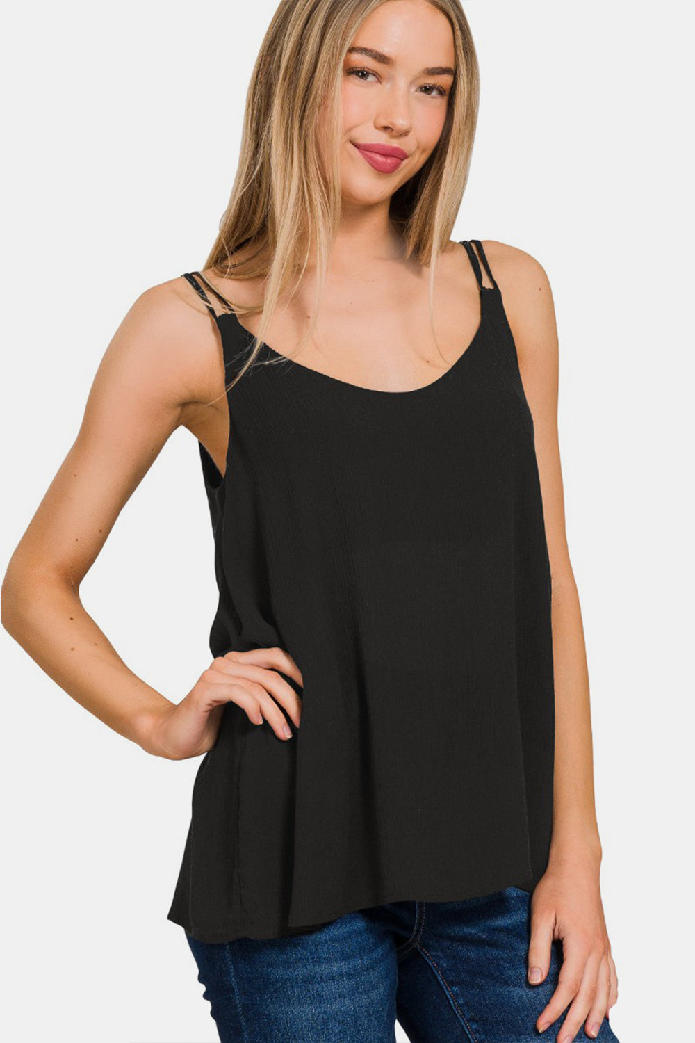 The Woven Double Spaghetti Strap V-Neck Cami is a stylish and versatile top that is perfect for layering or wearing on its own. The double spaghetti straps add a touch of sophistication and detail to the V-neckline. Made from woven fabric, this cami drapes beautifully and feels luxurious against the skin.  S - L