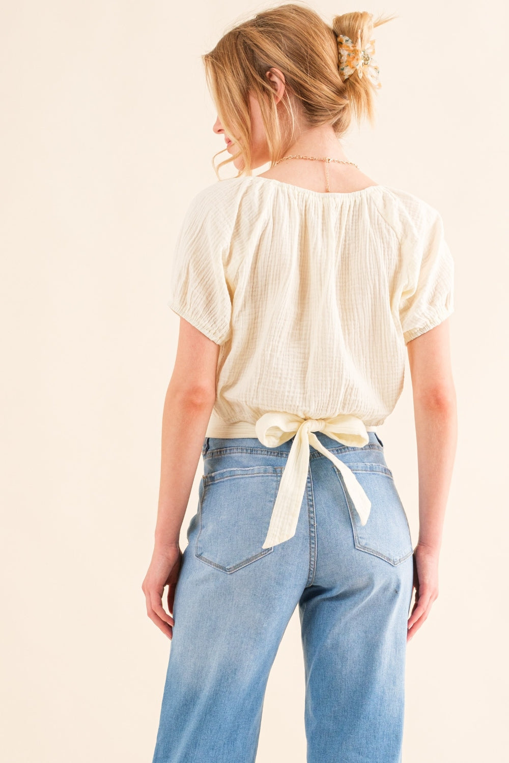 This Cotton Gauze Back Waist Tie Cropped Top is a stylish and versatile piece for your wardrobe. The back waist tie adds a unique touch to the design. Made with lightweight cotton gauze fabric, it is comfortable to wear in any season.  S - XL