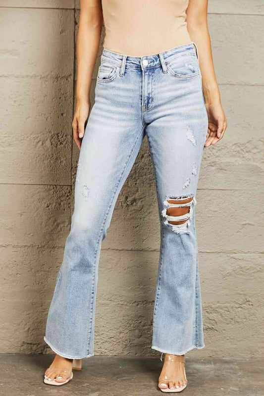 These jeans feature expert distressing that adds a worn-in appeal, giving you a perfectly lived-in look. The flattering mid-rise waist offers a comfortable fit, while the flared leg adds a trendy, retro vibe to any outfit. 