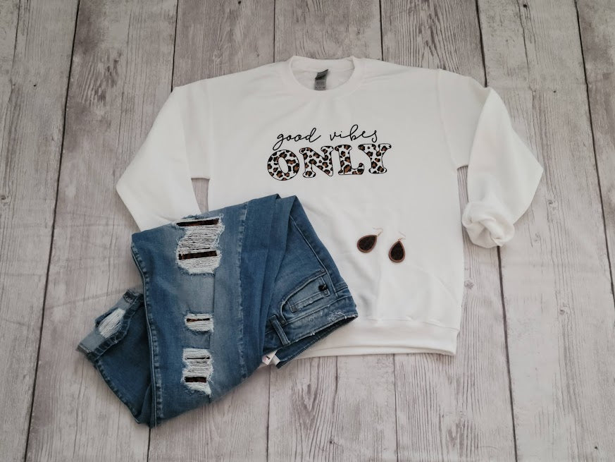 Imagine yourself in this comfy white long sleeve sweatshirt.  This sweatshirt features leopard and black print lettering.  This is a great staple piece. We all need a cute comfy sweatshirt to throw on to run errands, sit by the fire, hang out with friends, or just to be comfy in.
