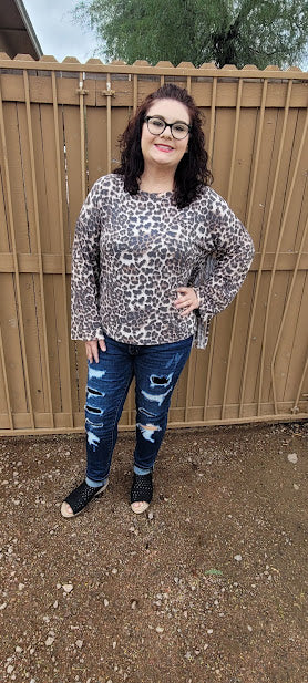 Leopard print top with v-neckline, long sleeves and fringe back. This cute shirt adds a little sass to your life. "Fringe With Benefits" is very unique, so you will not find another one like it! Go ahead and put your boots on! Go dancing, or to the rodeo, wear this cutie for any reason, or no reason at all. Strut your stuff! Sizes small through large.